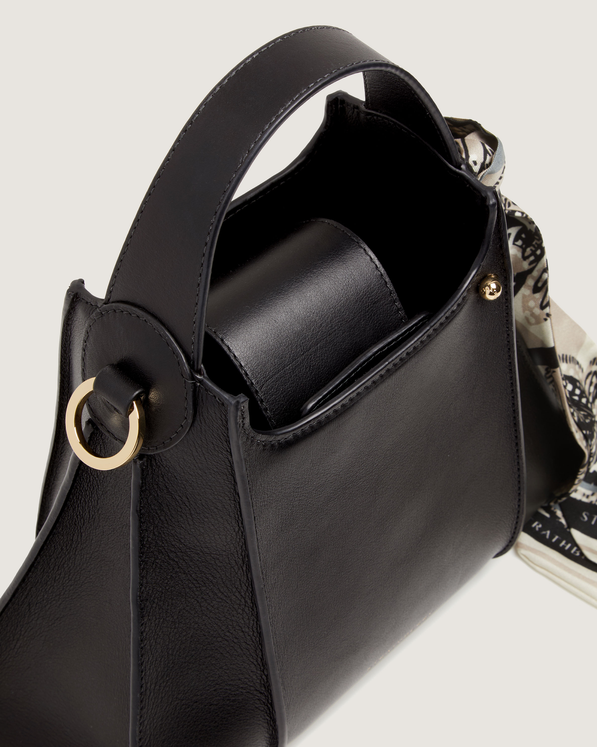 A black handbag with a gold ring on the handle