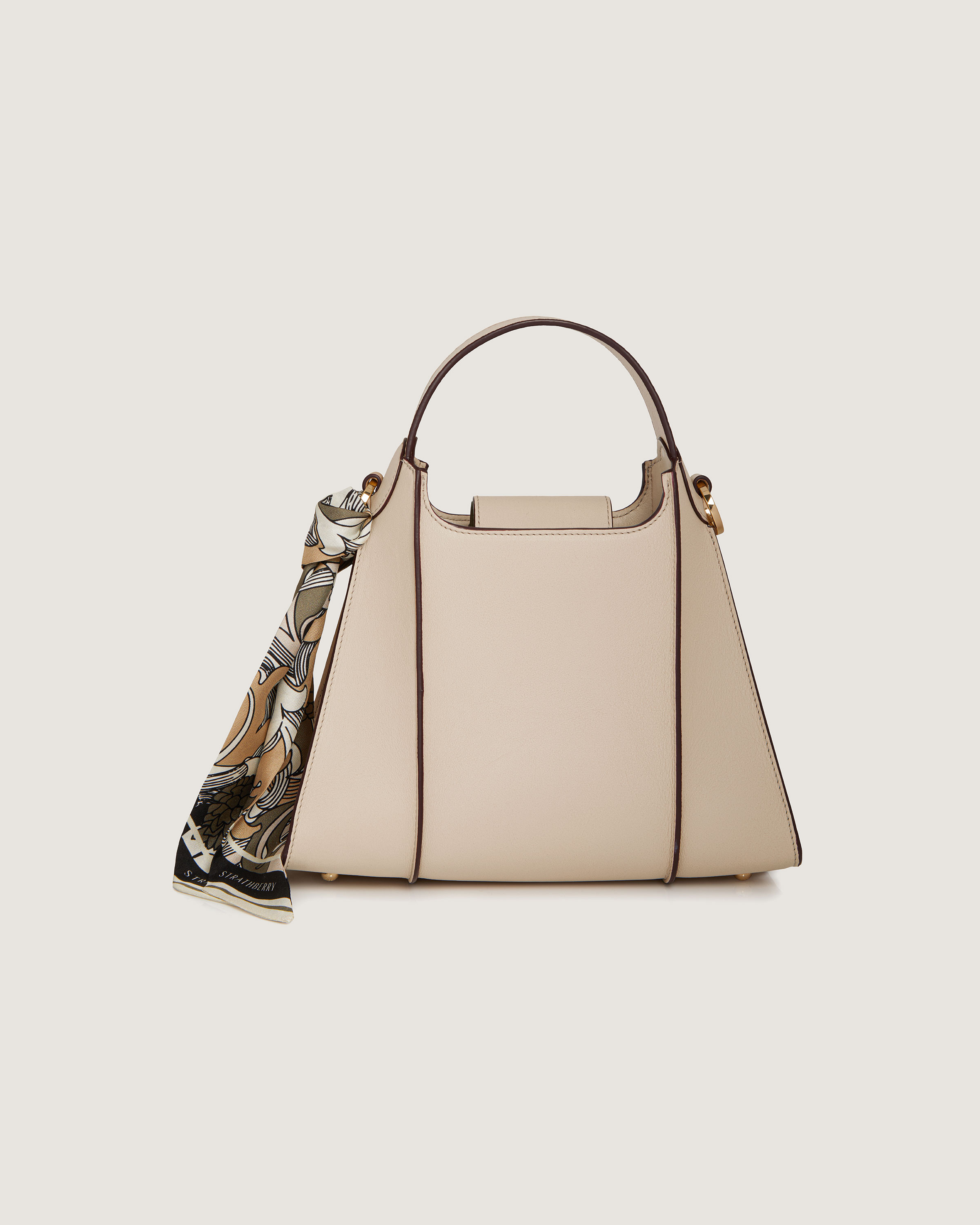 A beige handbag with a tasselled strap