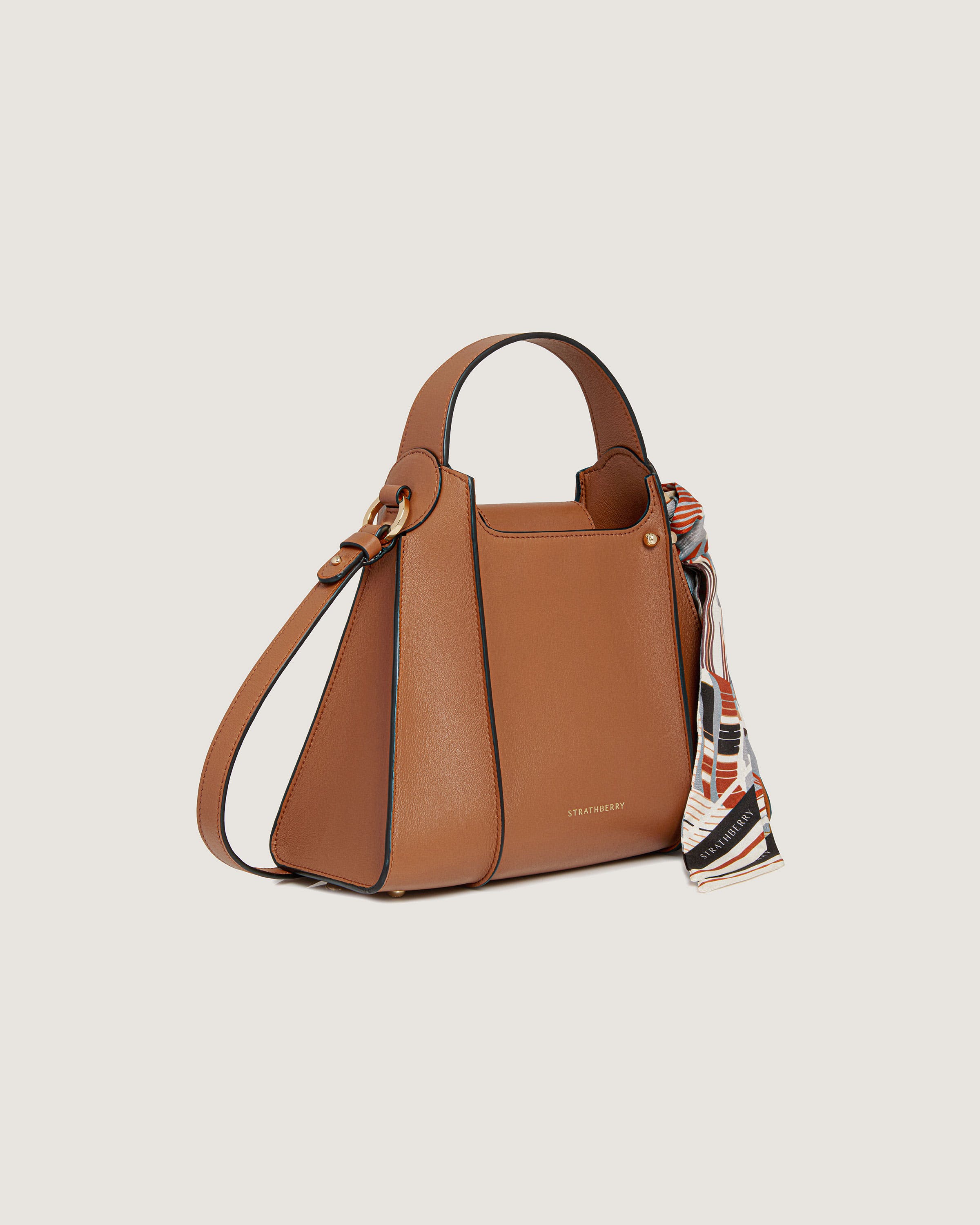 A brown handbag with a scarf hanging from it