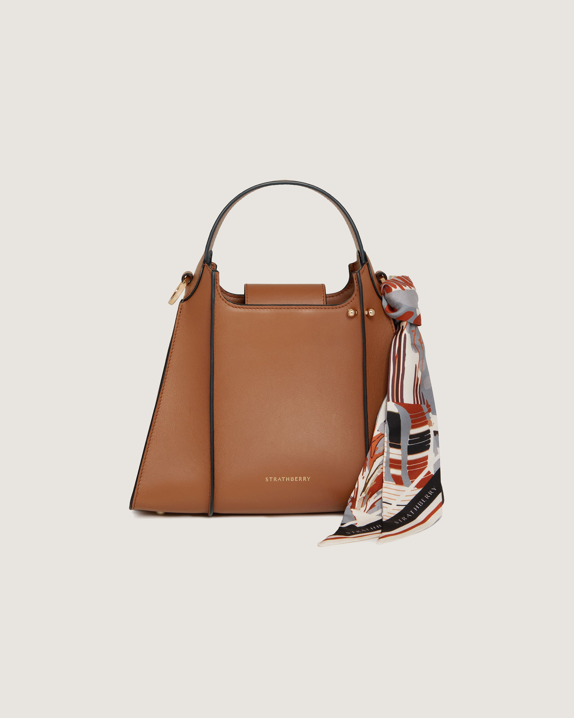 A brown handbag with a scarf around it