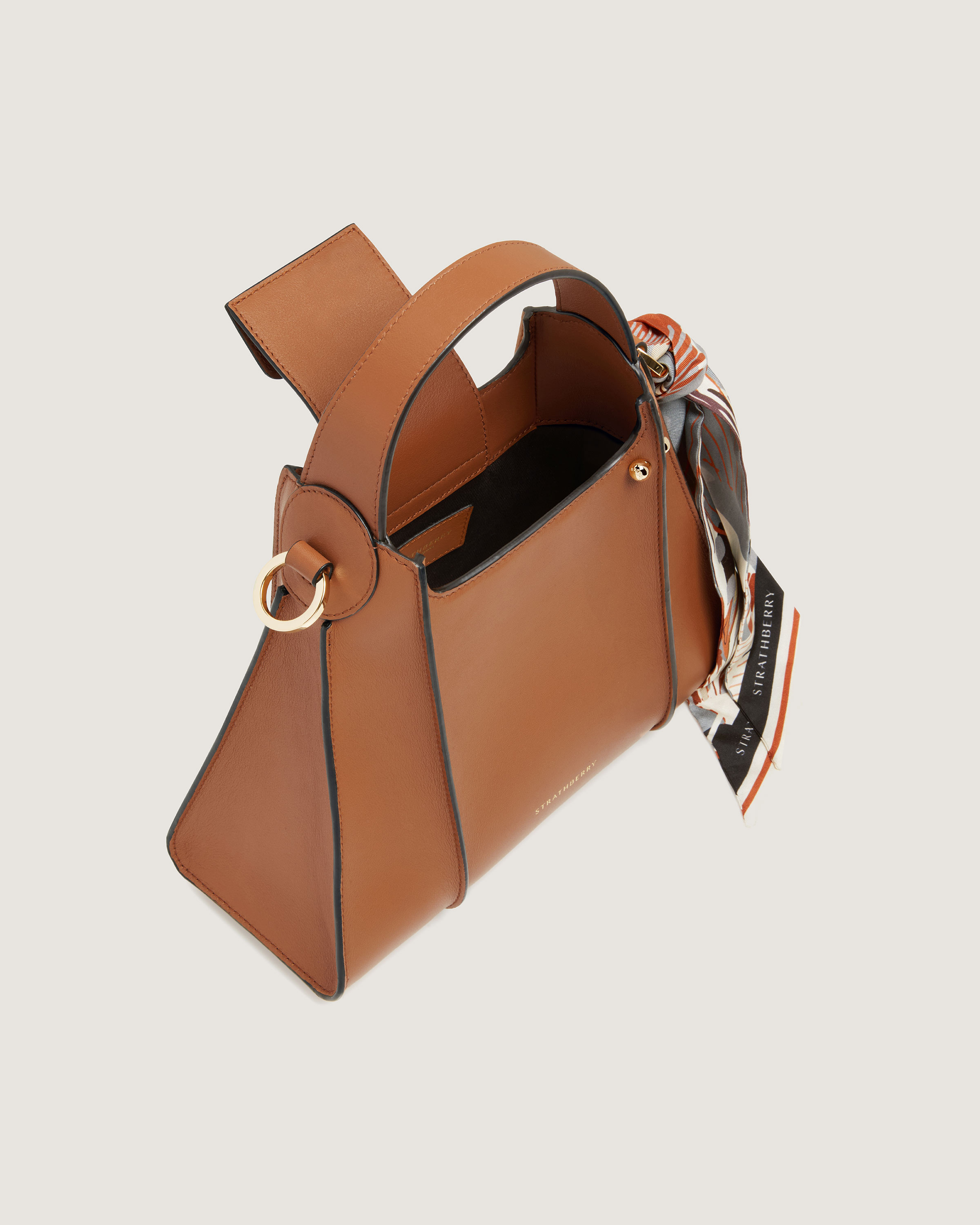 A brown handbag with a bow on the handle