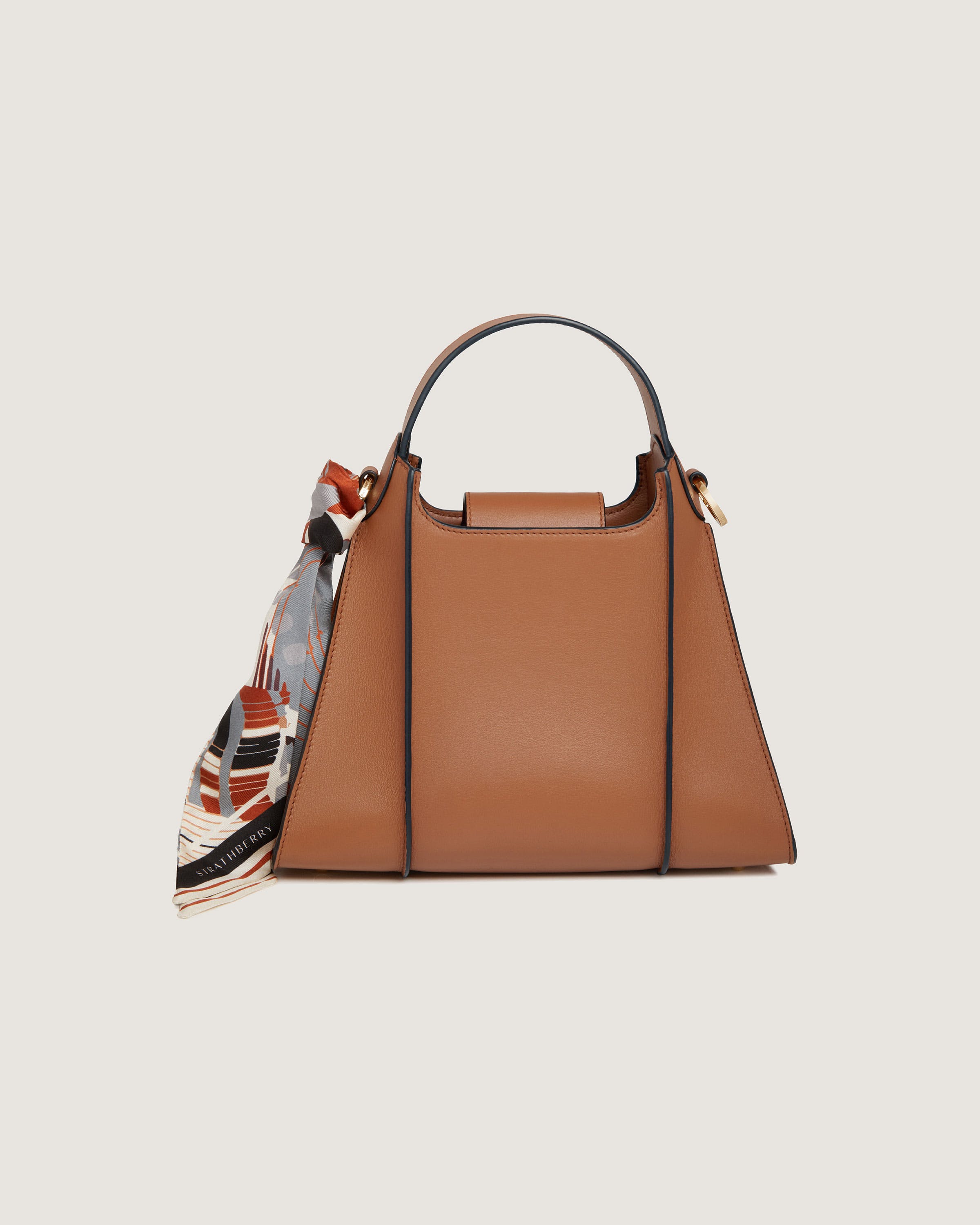 A brown handbag with a scarf hanging from it