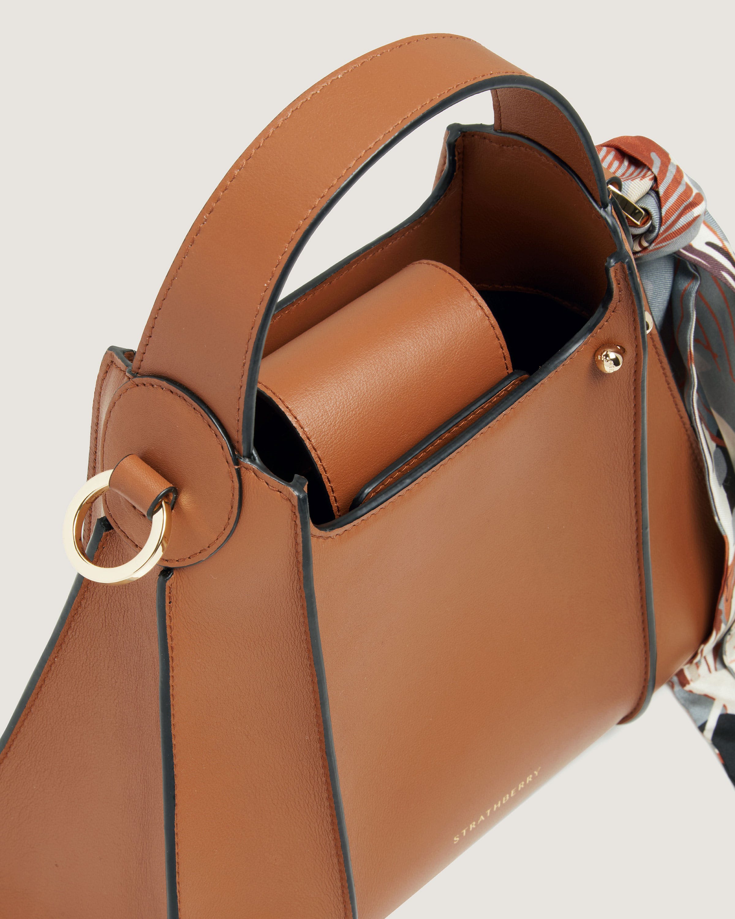 A brown handbag with a gold ring on the handle