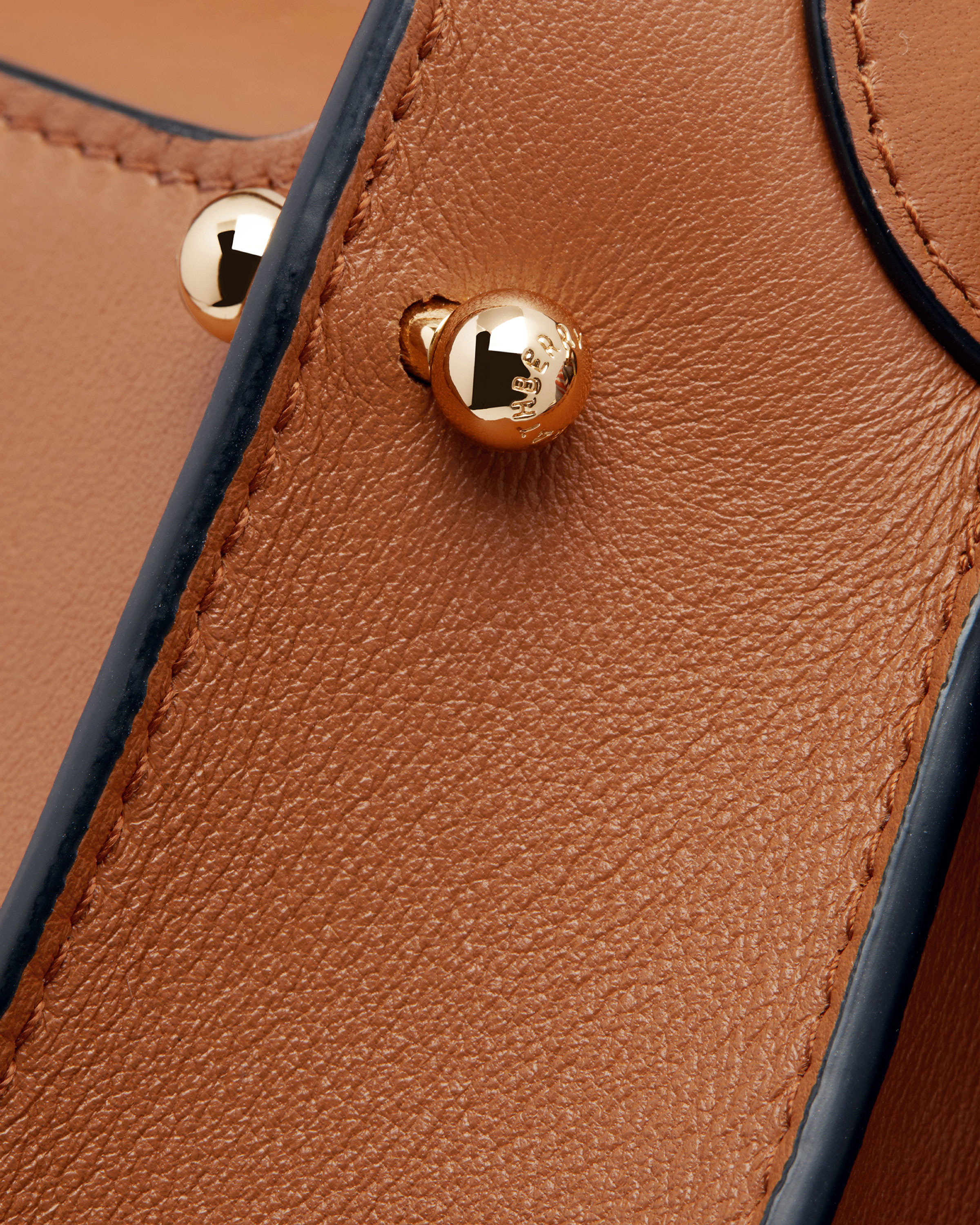 A close up of a brown and blue purse