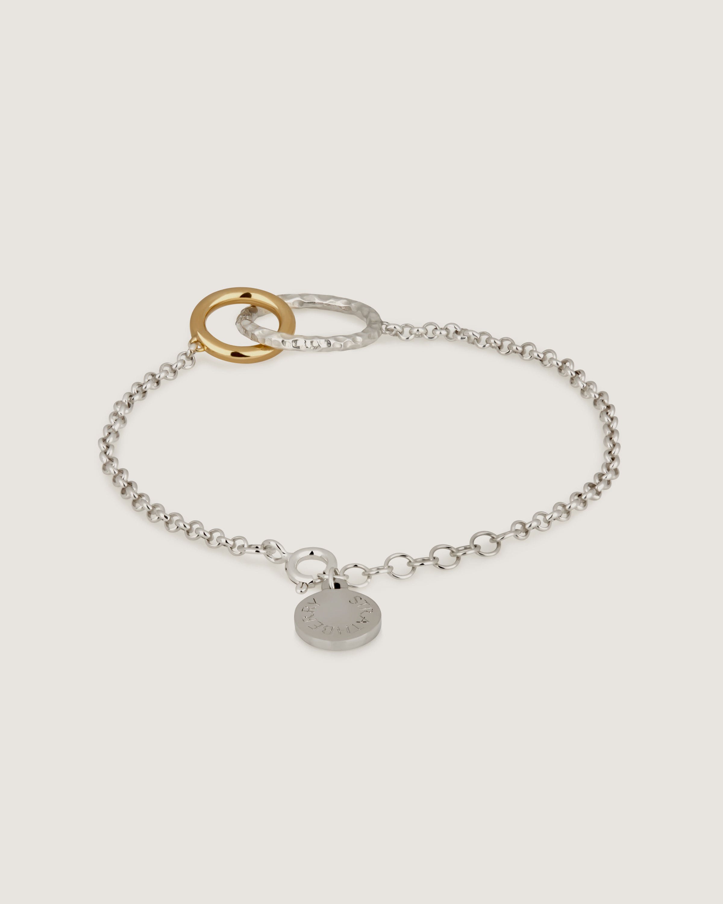 A silver bracelet with a heart charm