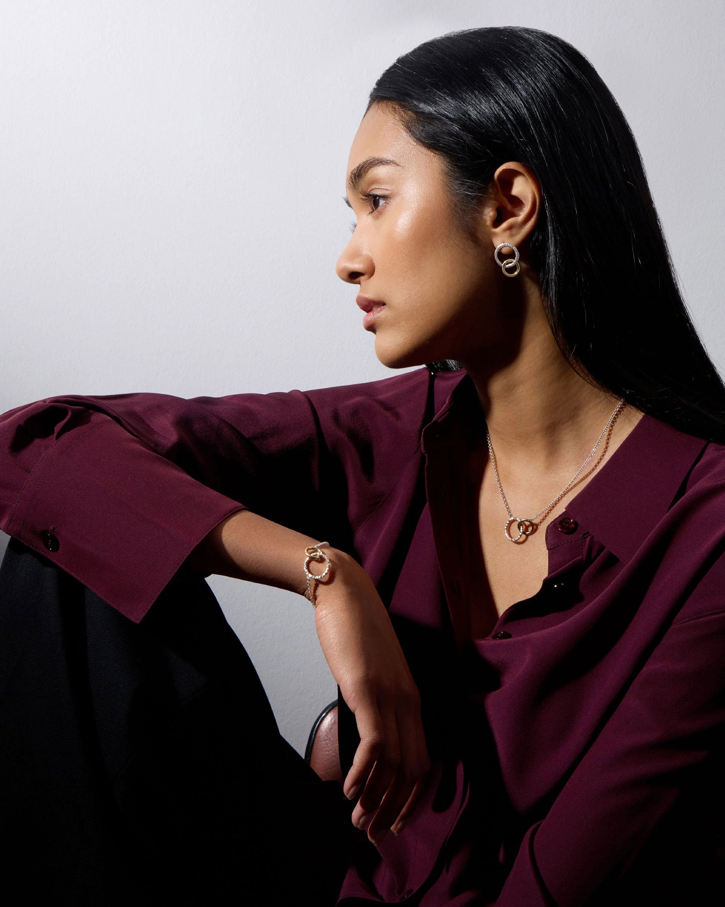 A woman in a purple shirt is sitting down