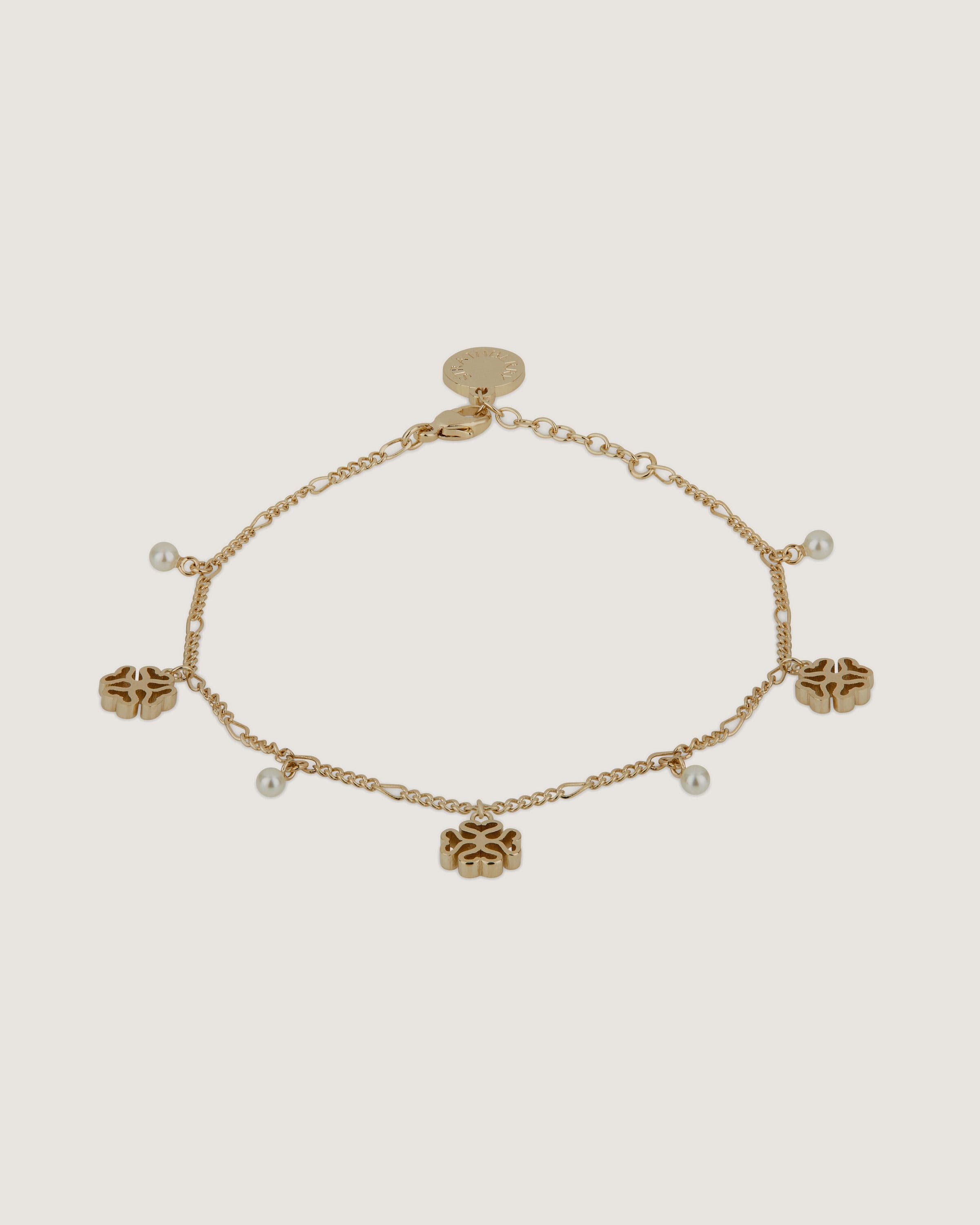 A gold bracelet with five charms