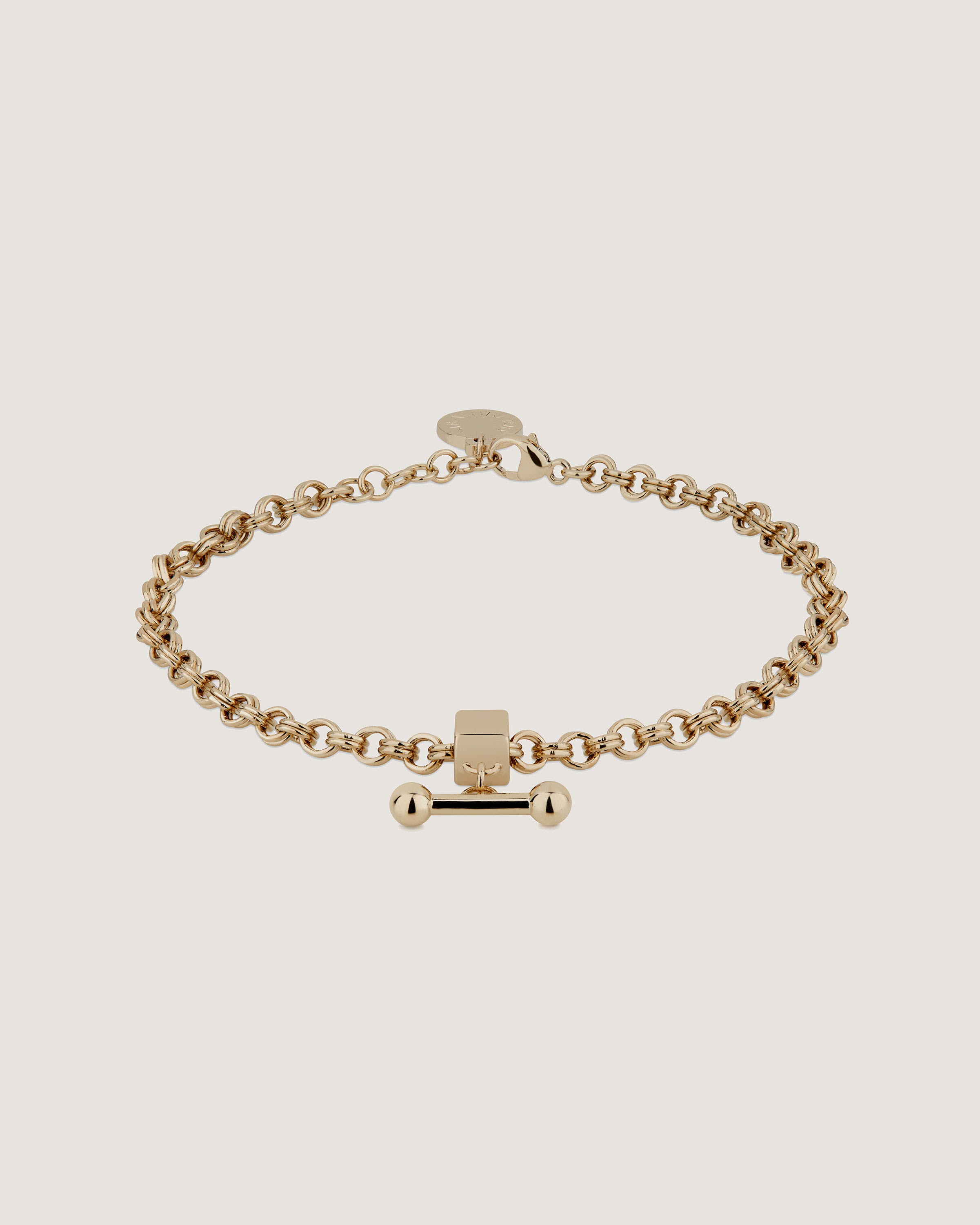 A gold bracelet with a cross on it