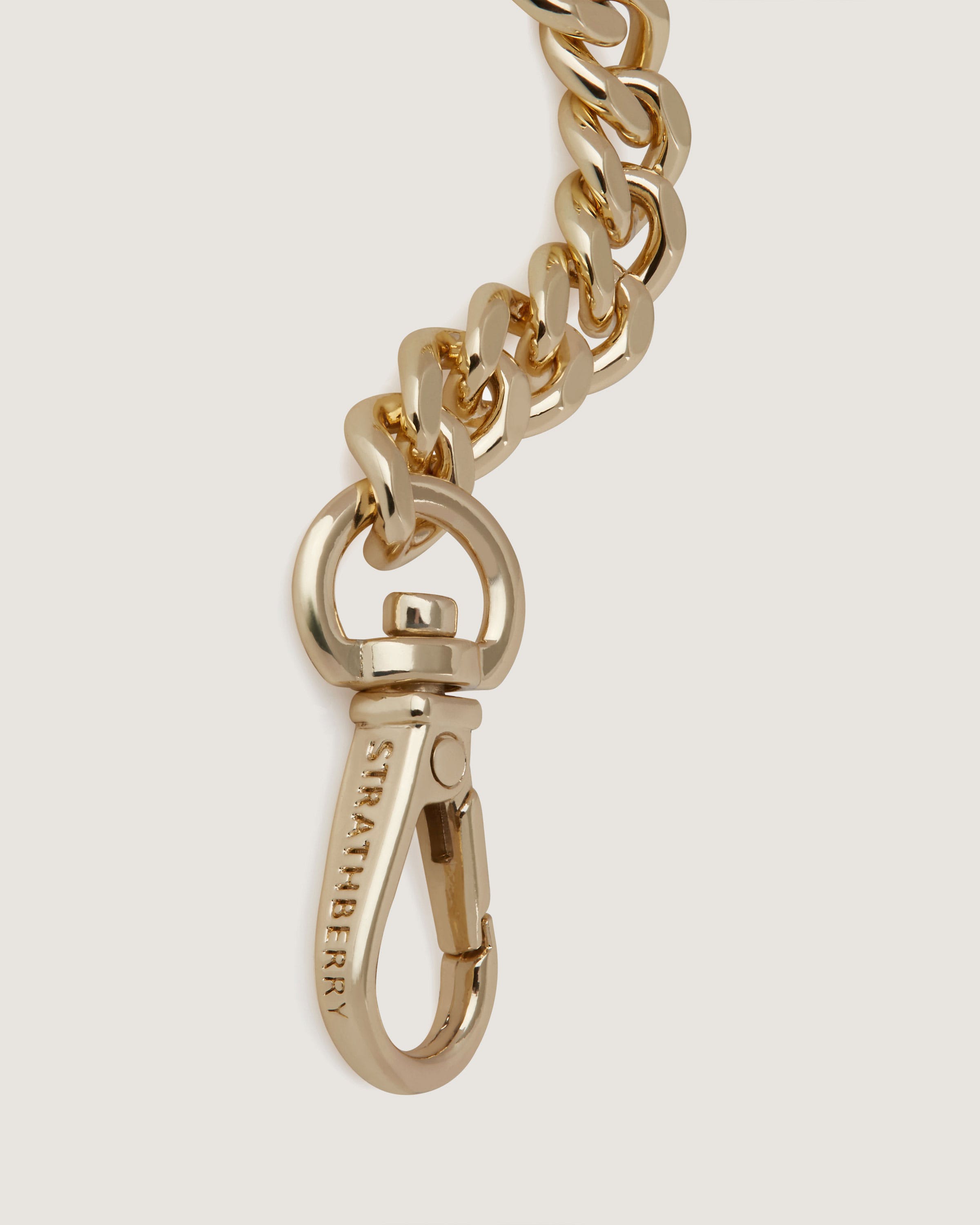 A gold chain is attached to a keychain