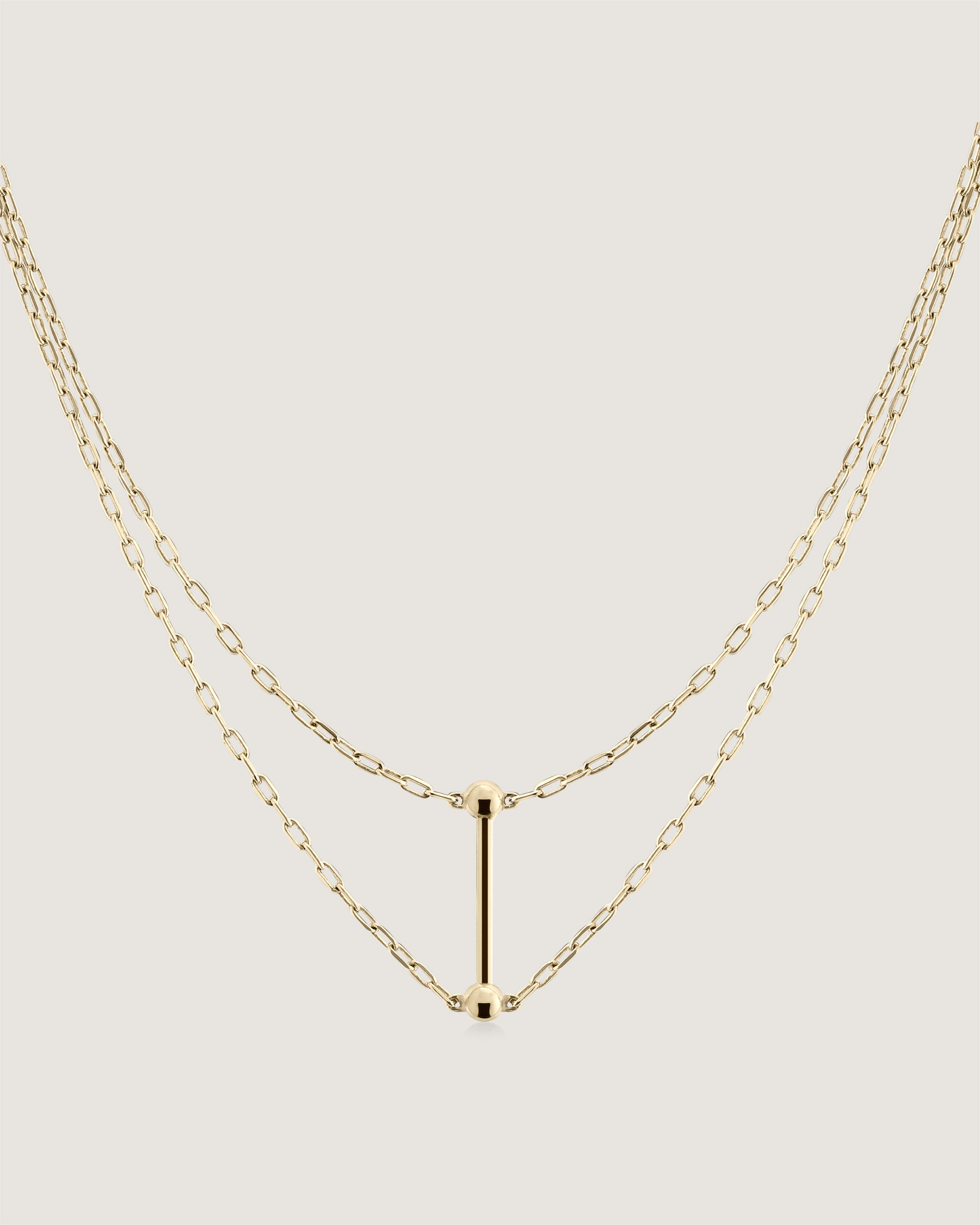 A gold necklace with a letter on it