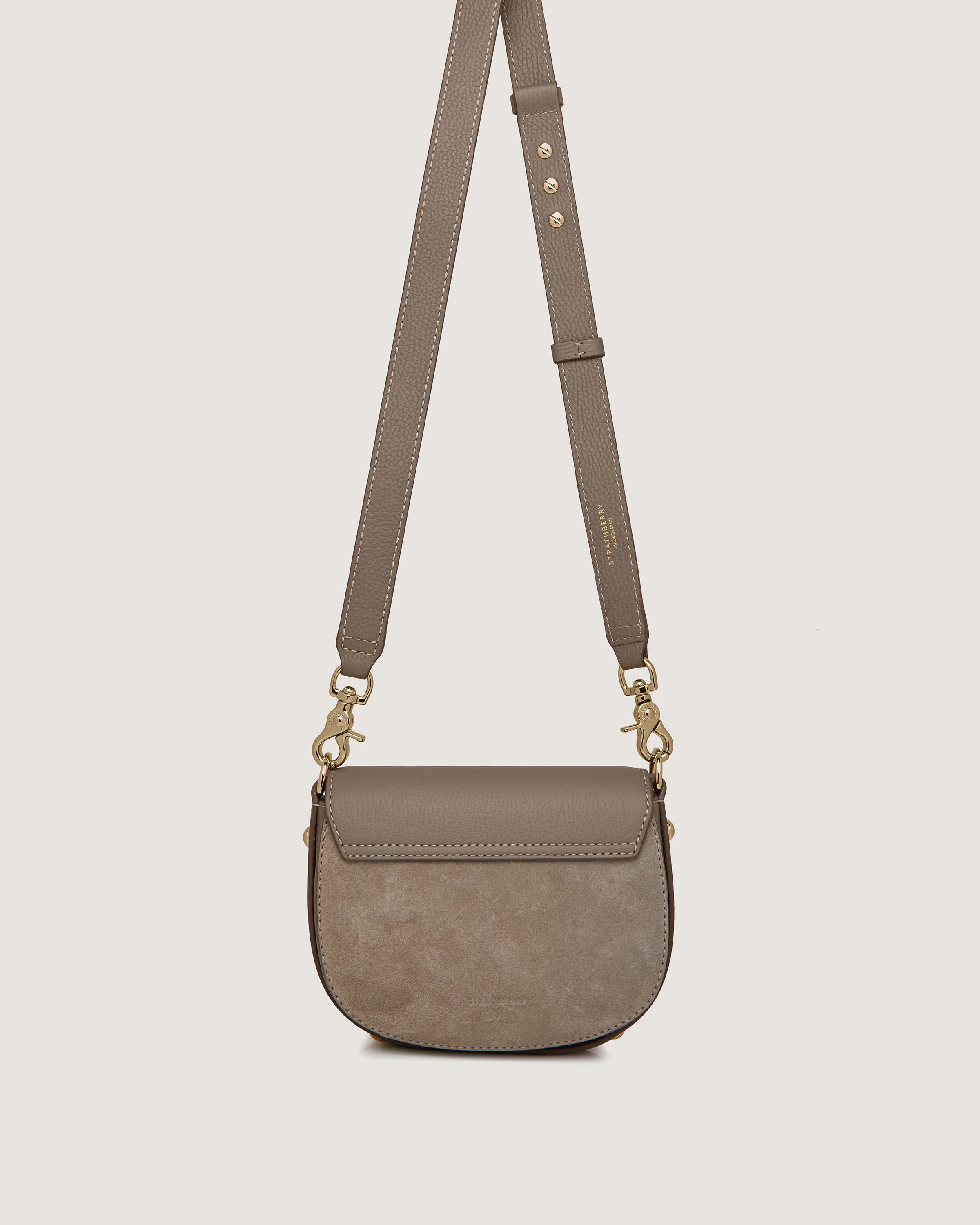 A small cross body bag on a white background