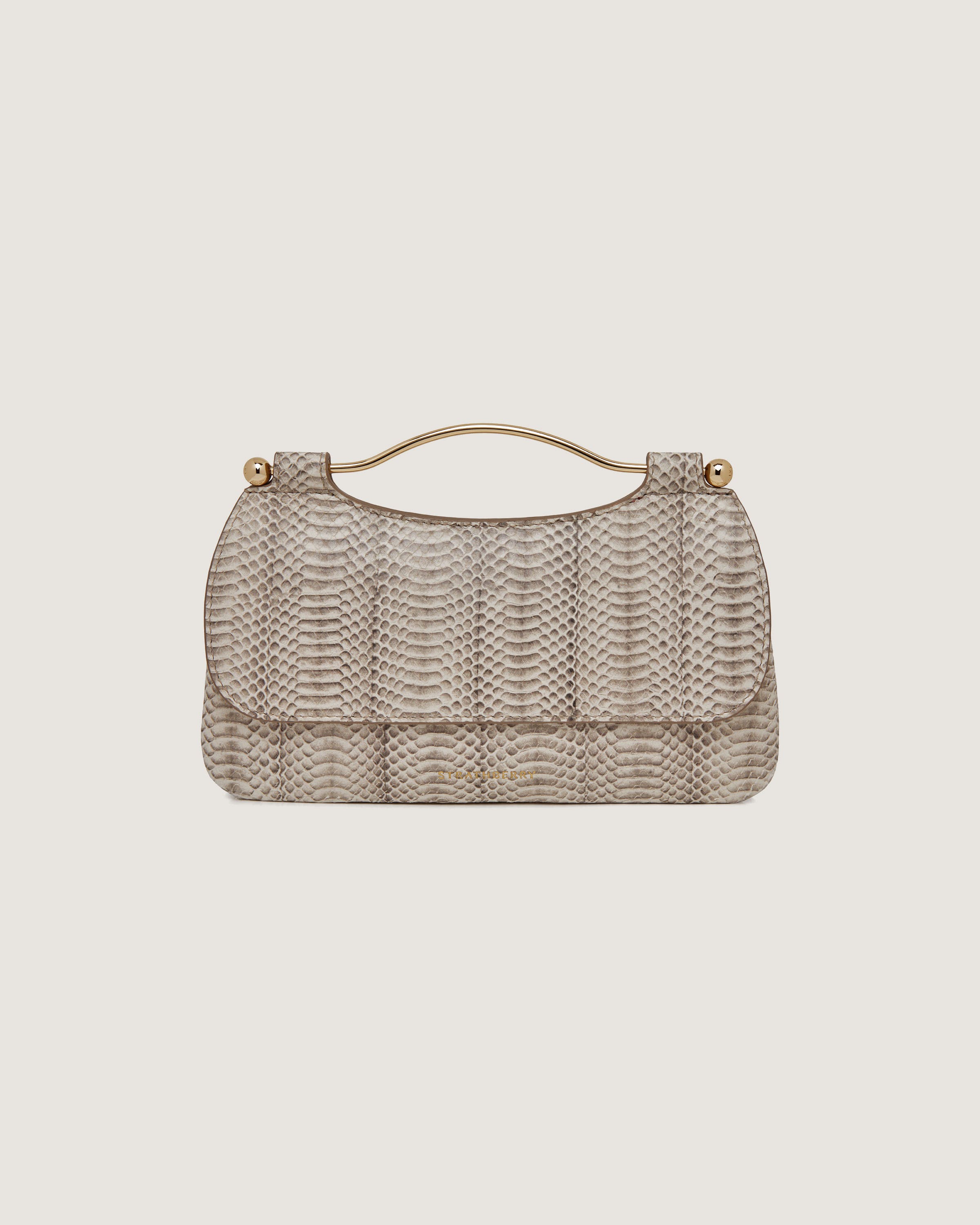 A beige handbag with a snake skin pattern