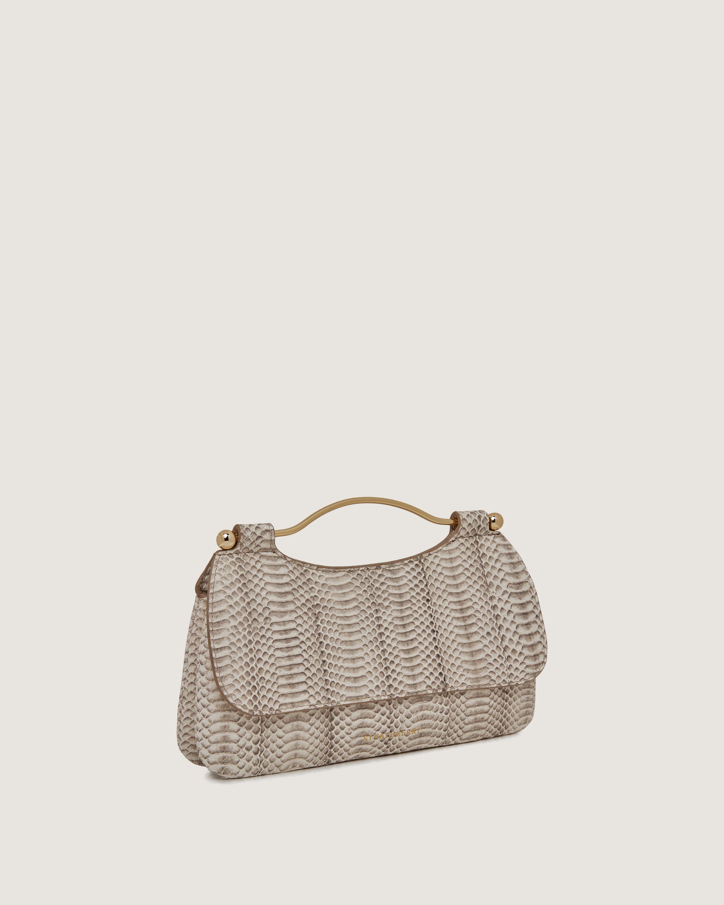 A beige handbag on a white background