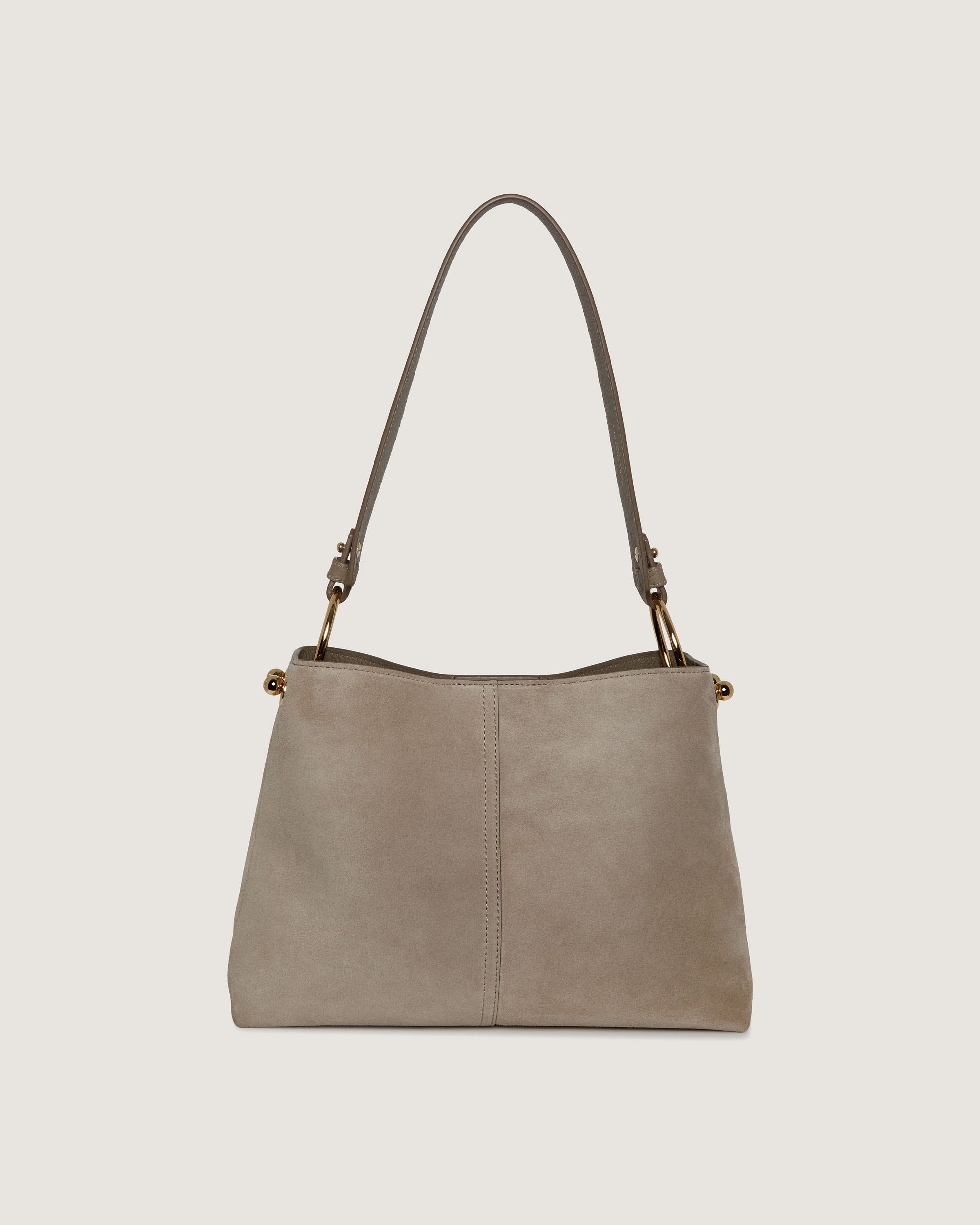 A beige leather handbag on a white background