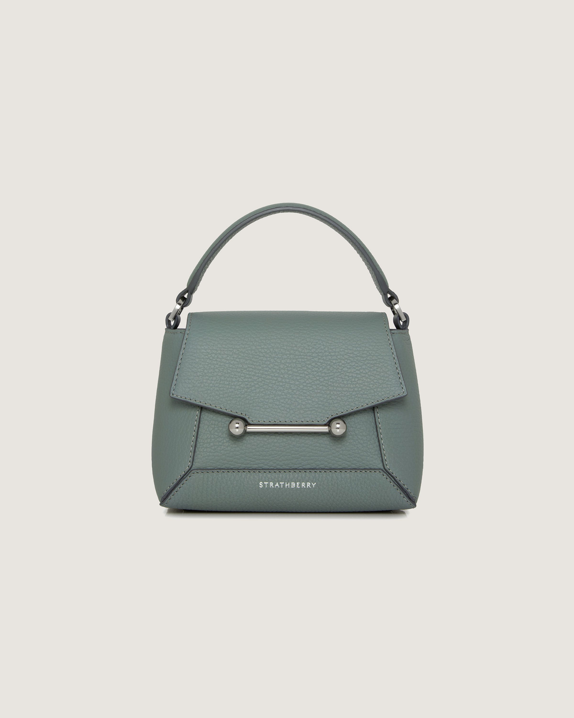 A green handbag with a metal handle