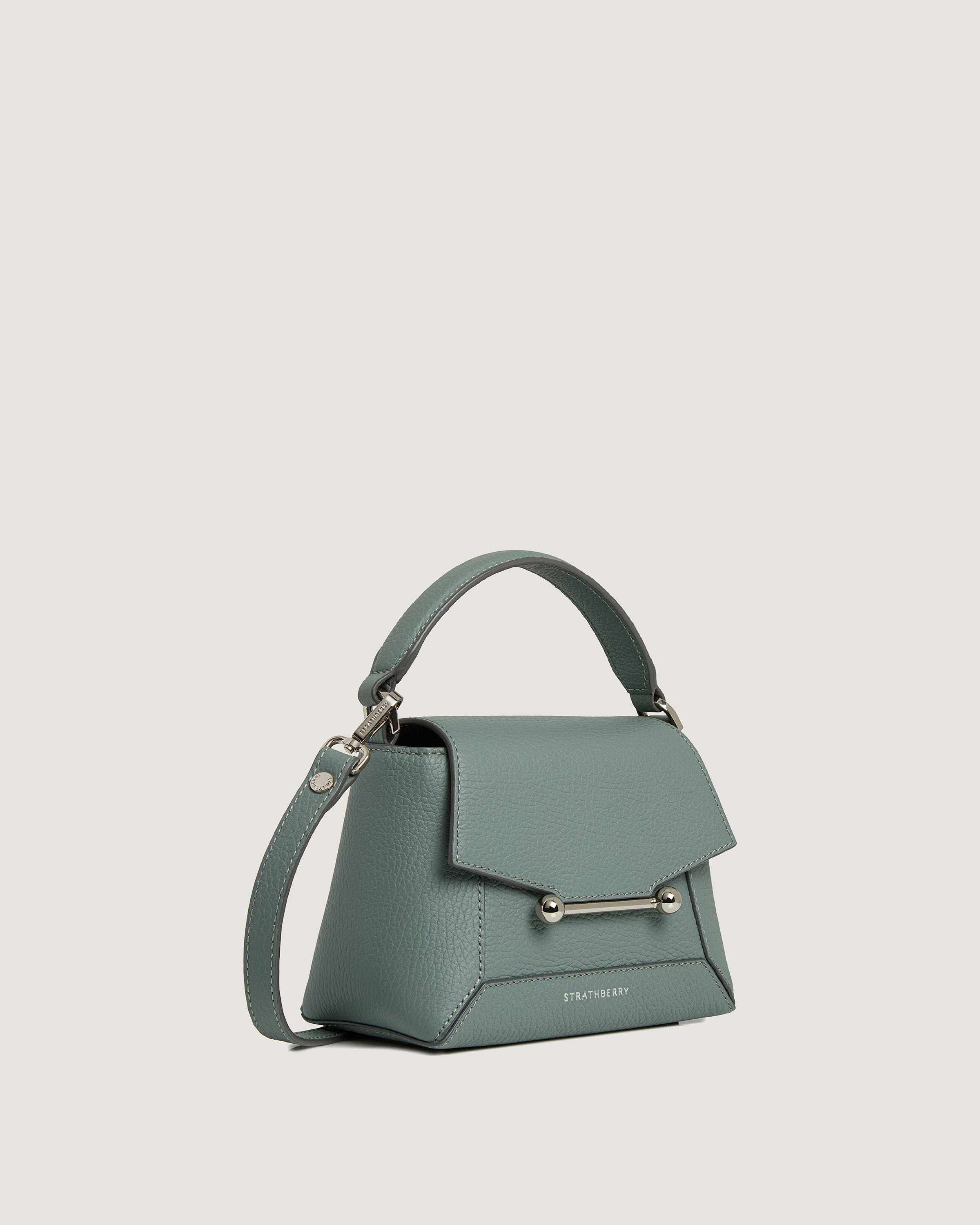 A small green handbag with a metal handle