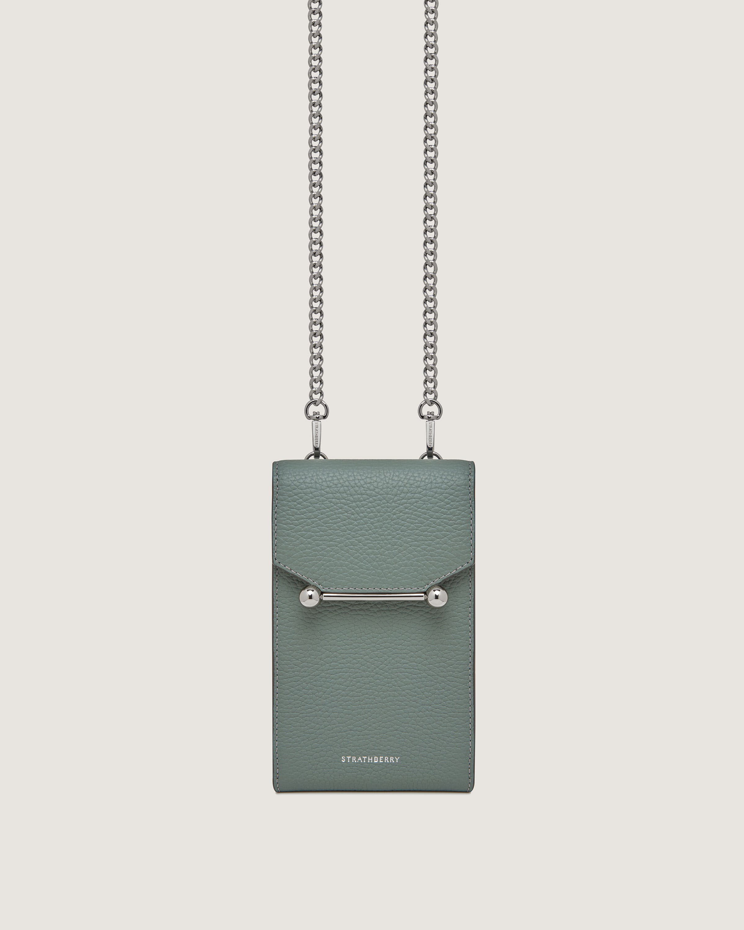 A green bag with a chain hanging from it