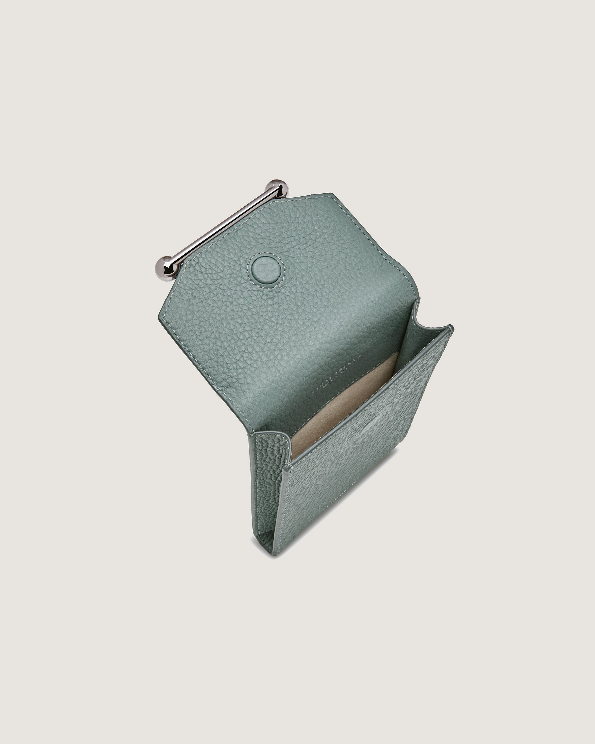 A small green purse with a metal handle