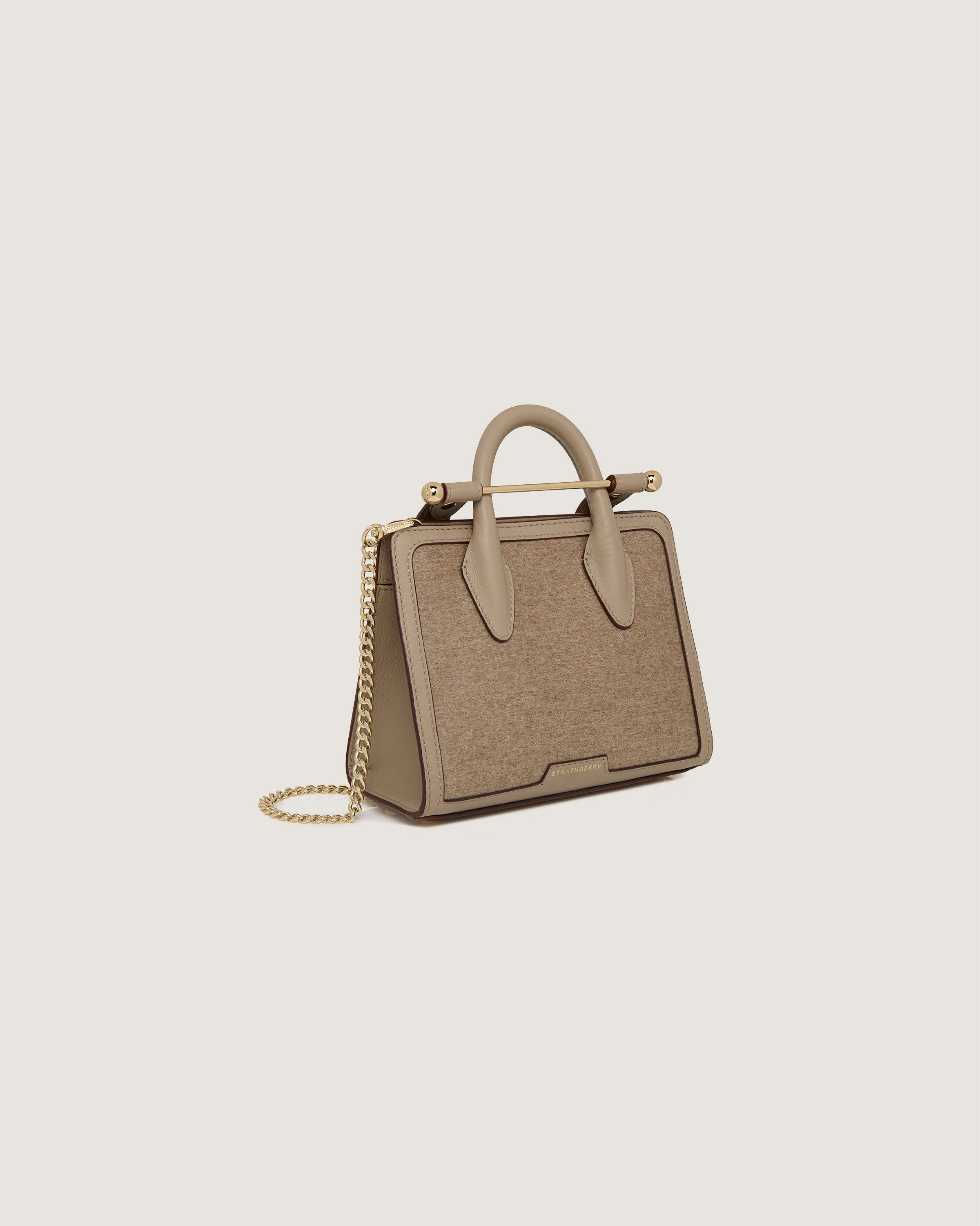 A beige handbag with a chain hanging from it