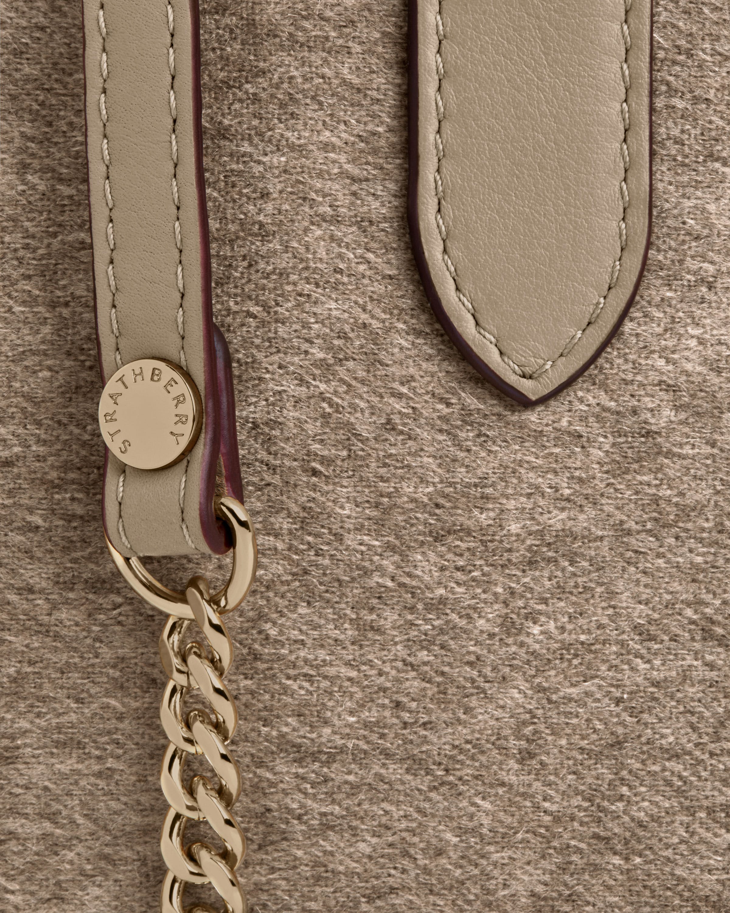 A close up of a handbag with a chain on it