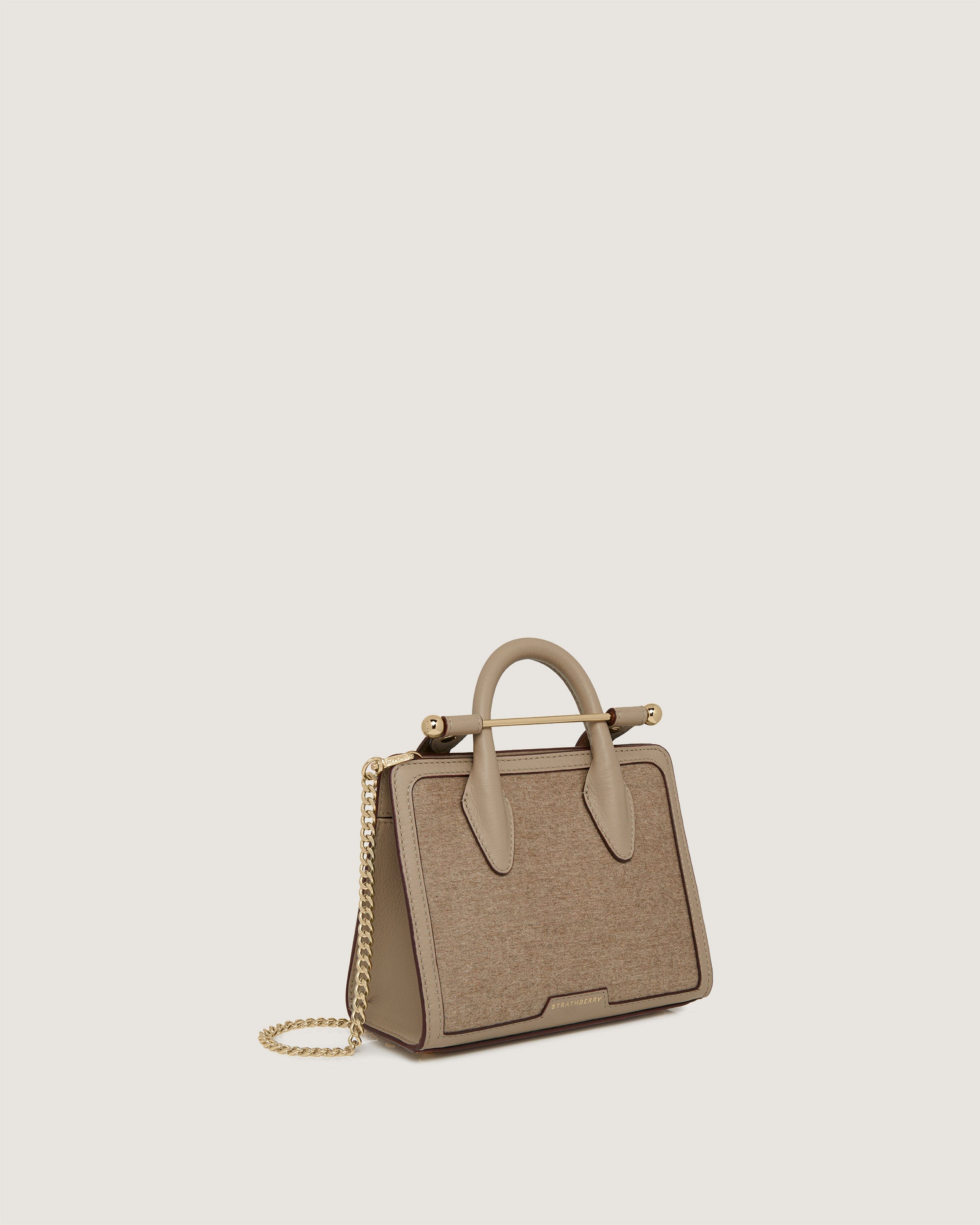 A beige handbag with a chain strap