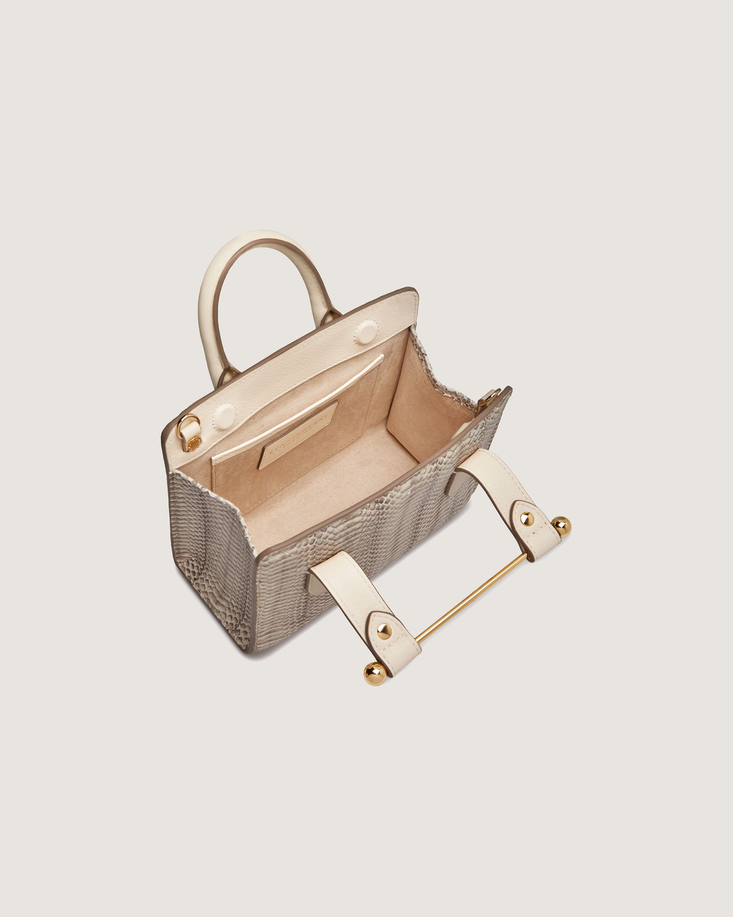 A beige handbag with handles and a handle