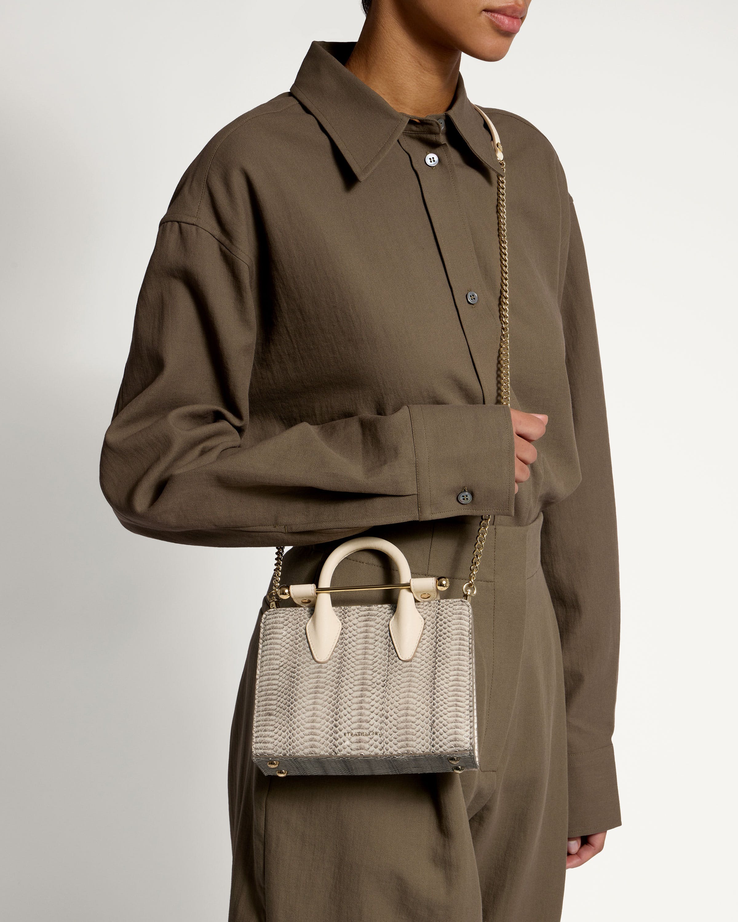 A woman is holding a white purse