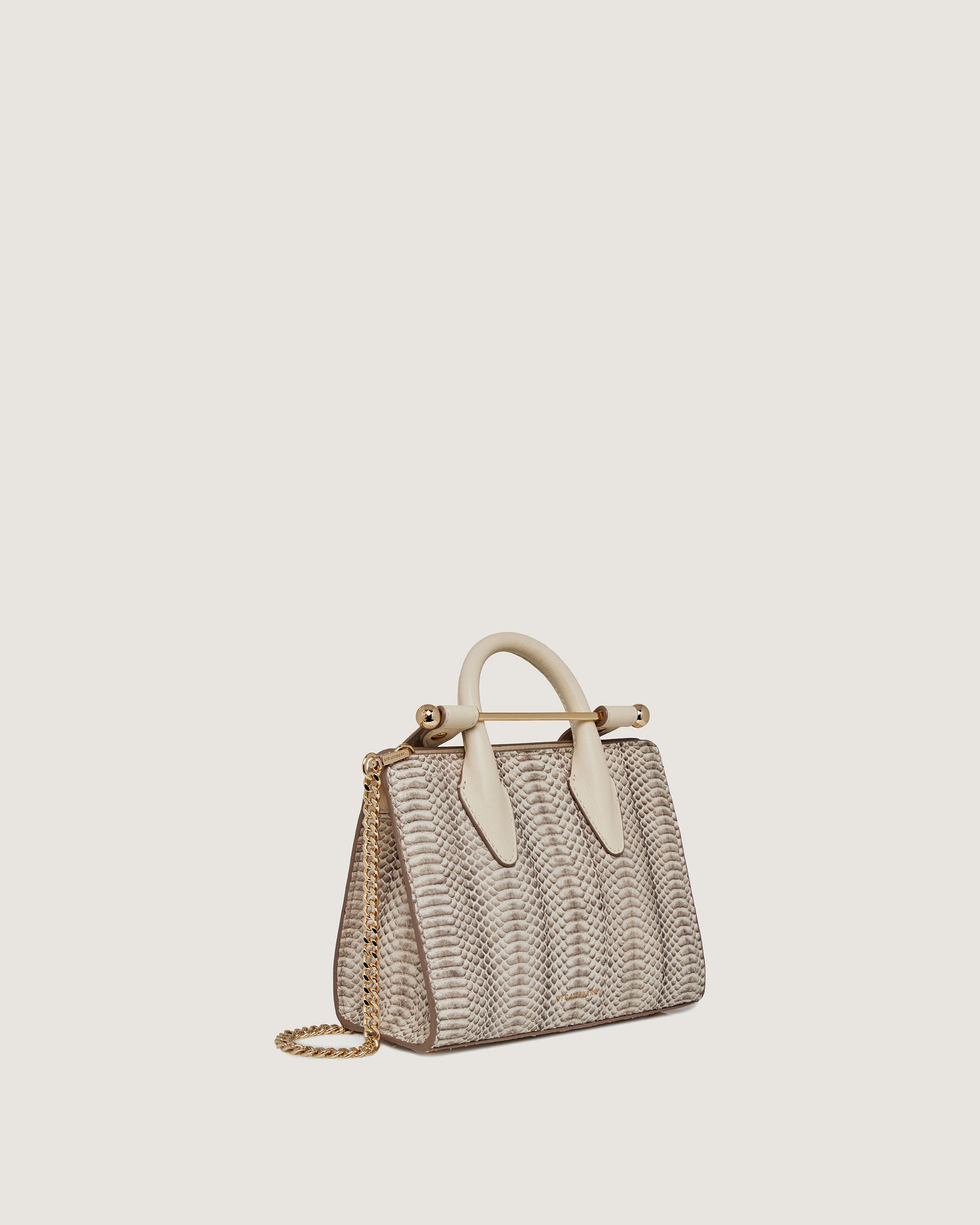 A handbag with a white handle and a beige handle