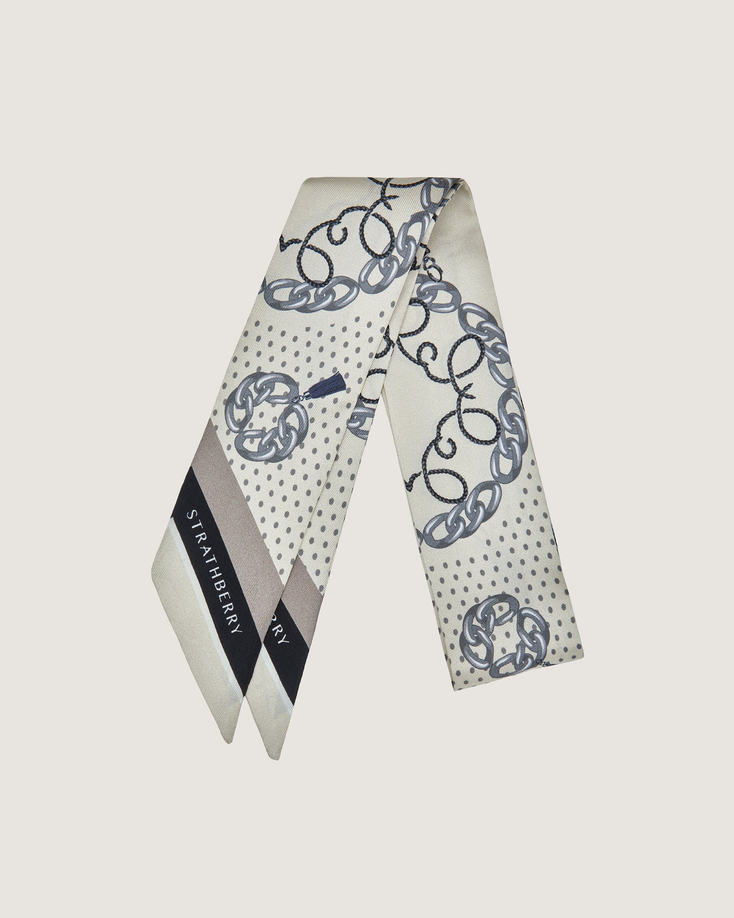 A white and blue scarf with a monogrammed design