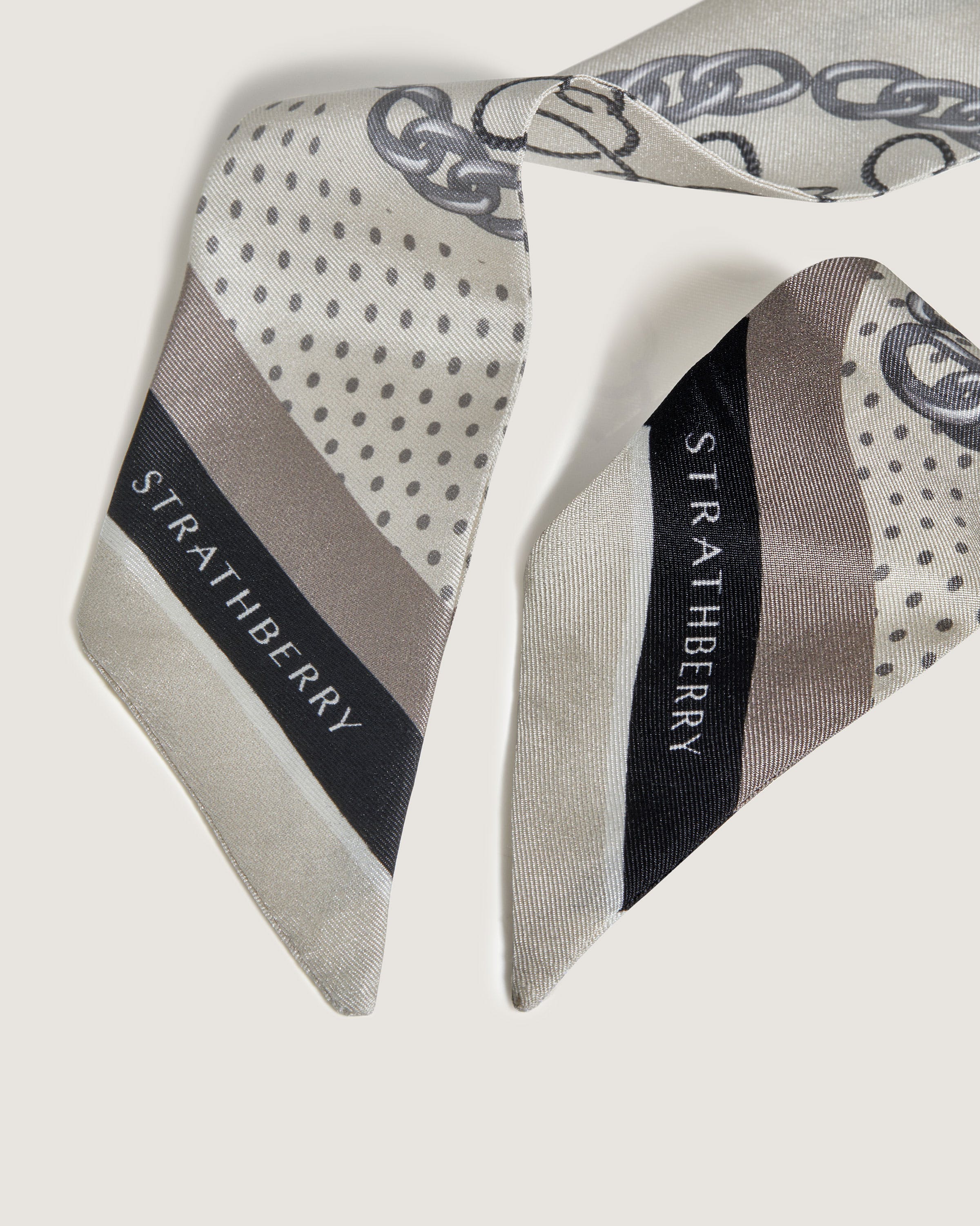 A white and grey tie with a black and white design