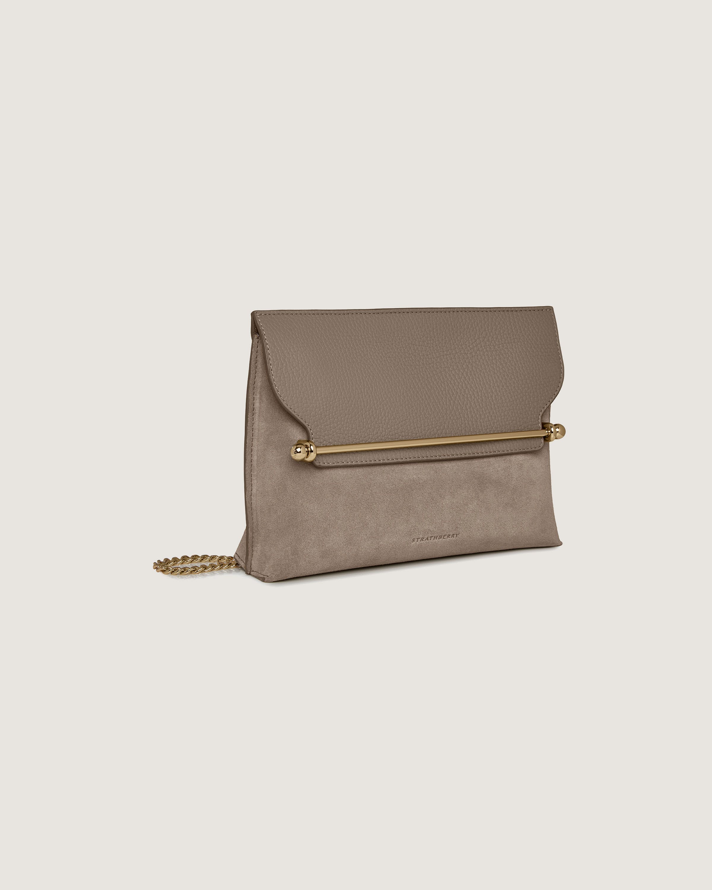 A beige clutch bag with a gold chain