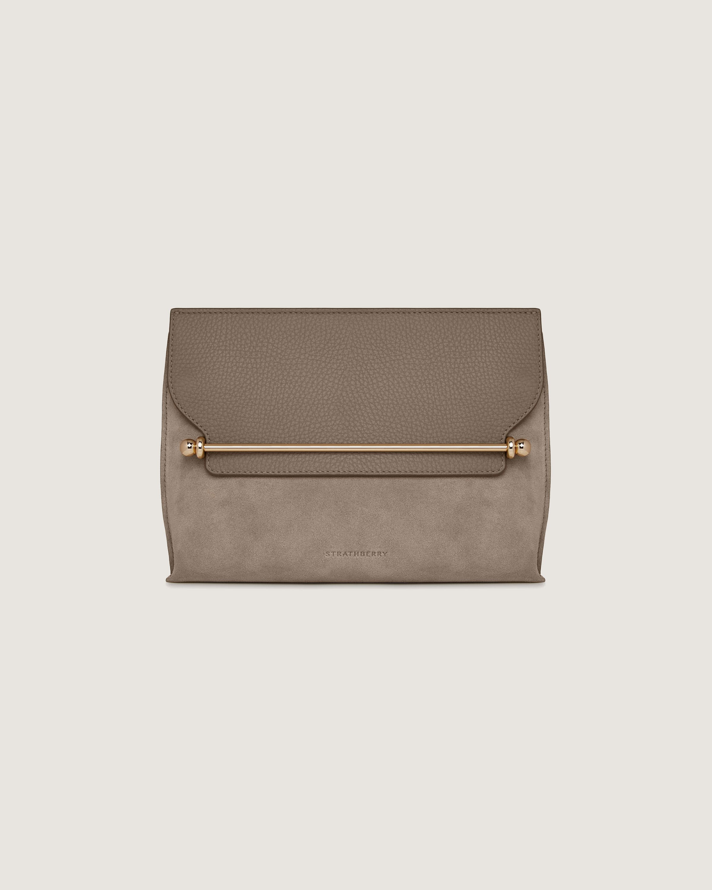 A grey clutch bag with a gold handle