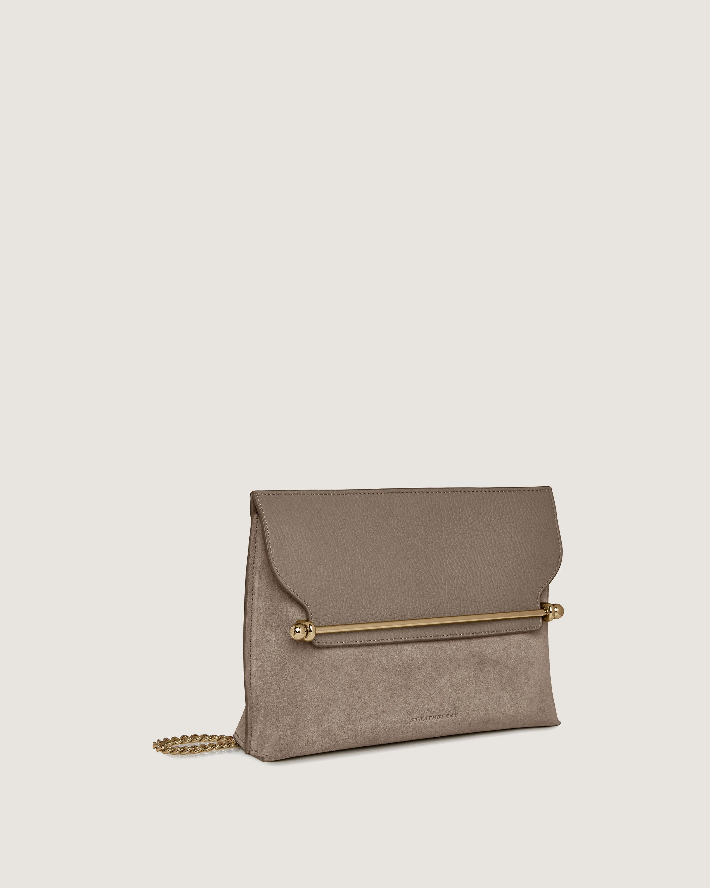 A beige clutch bag with a gold chain