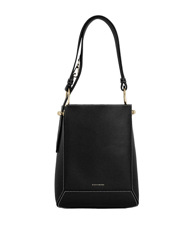 A black handbag on a green background