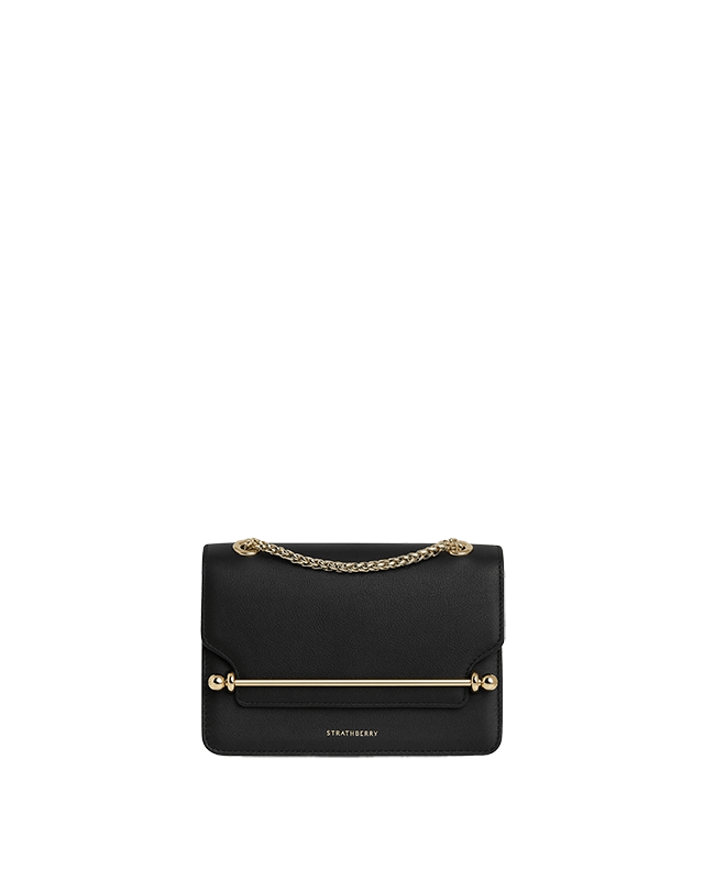 A black purse with a gold chain