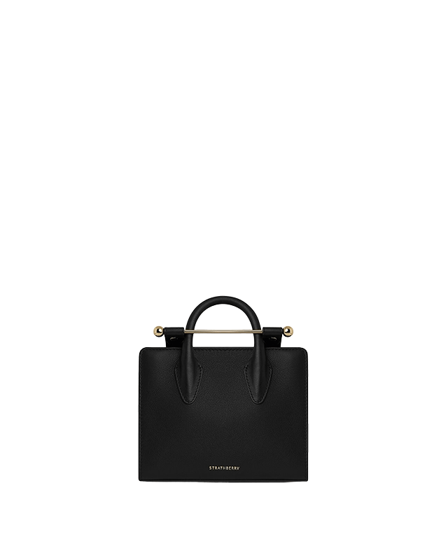 A black handbag on a green background