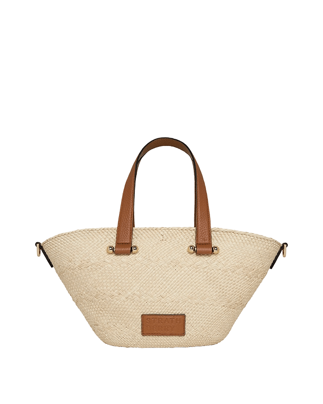 A white and brown handbag on a green background