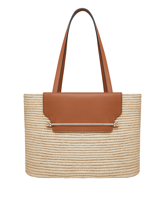 A brown and white handbag with a tan handle