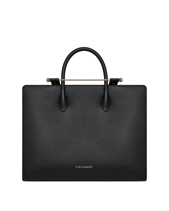 A black leather handbag with a gold handle