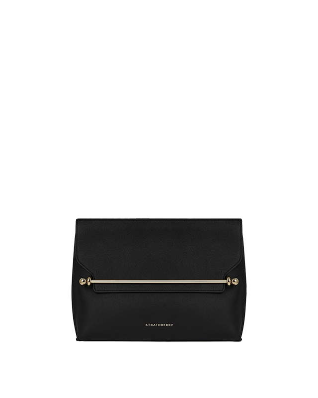 A black clutch bag on a green background