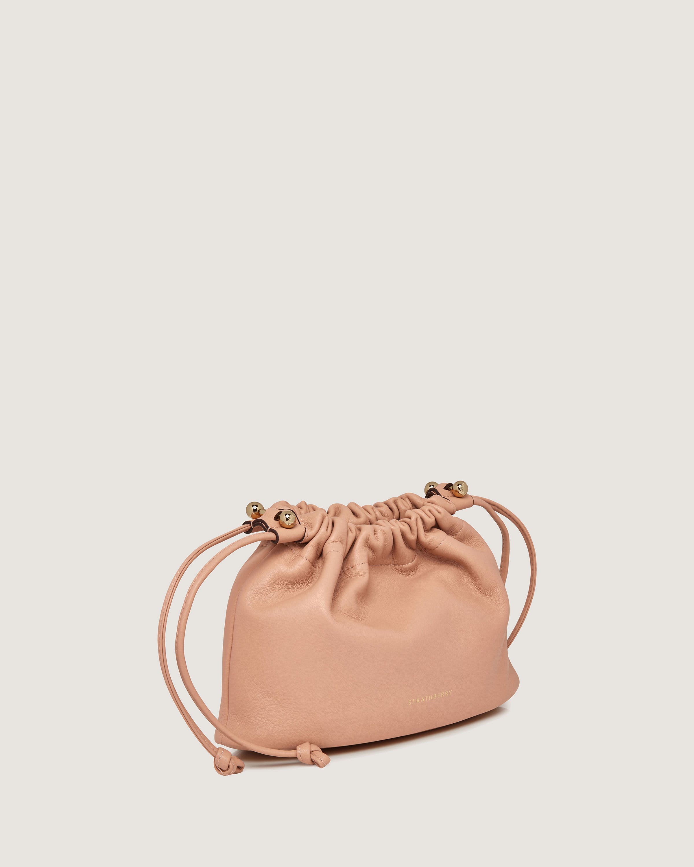 A small pink leather bag with a drawstring