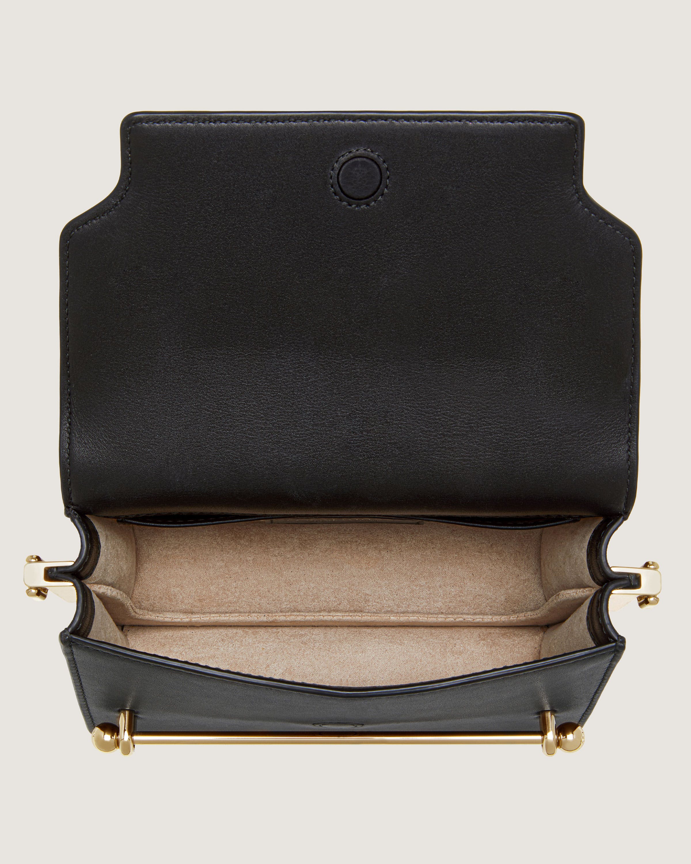 A black leather purse with a gold handle