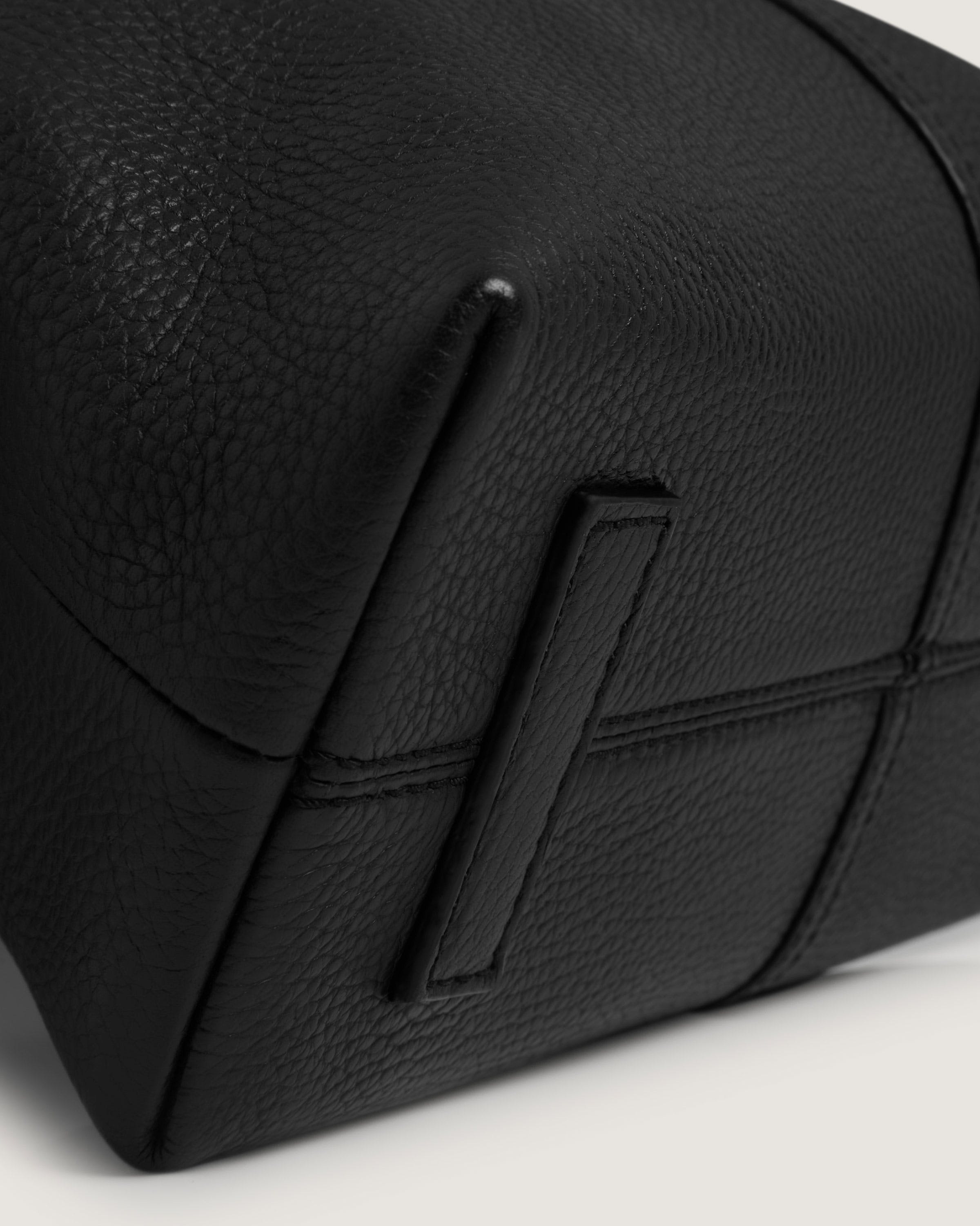 A black leather pouch with a zipper