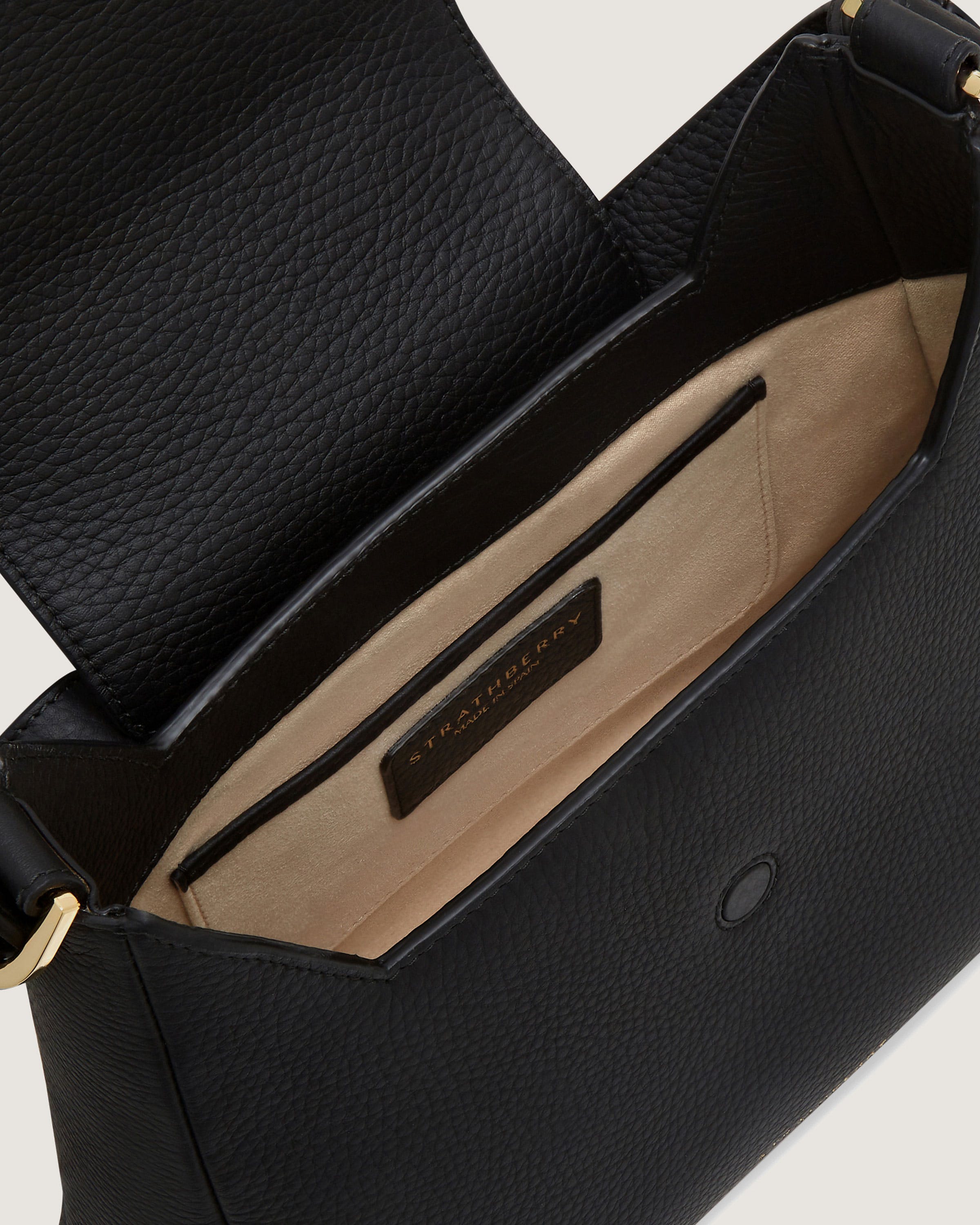 A black handbag with a zippered compartment