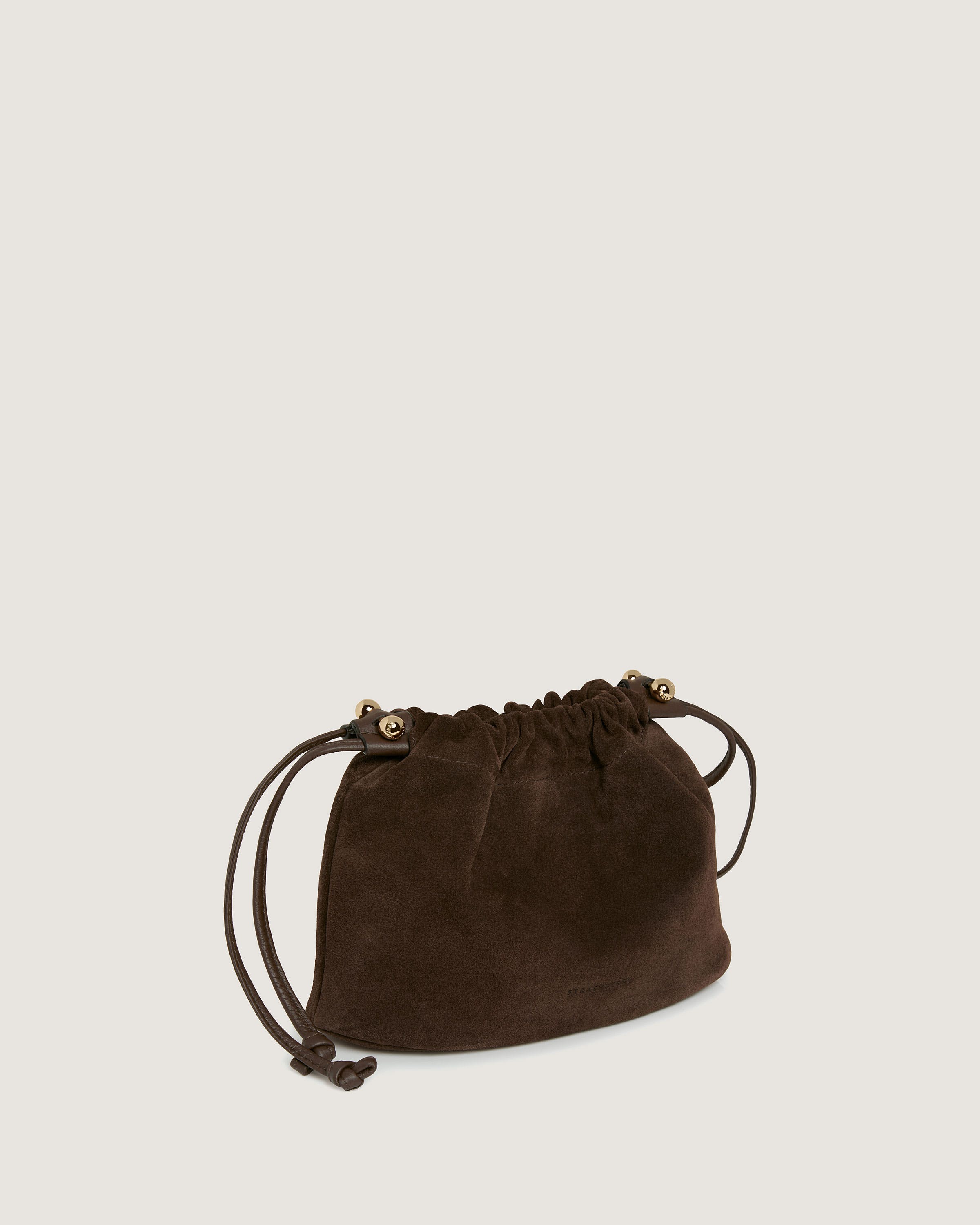 A brown sued bag on a white background