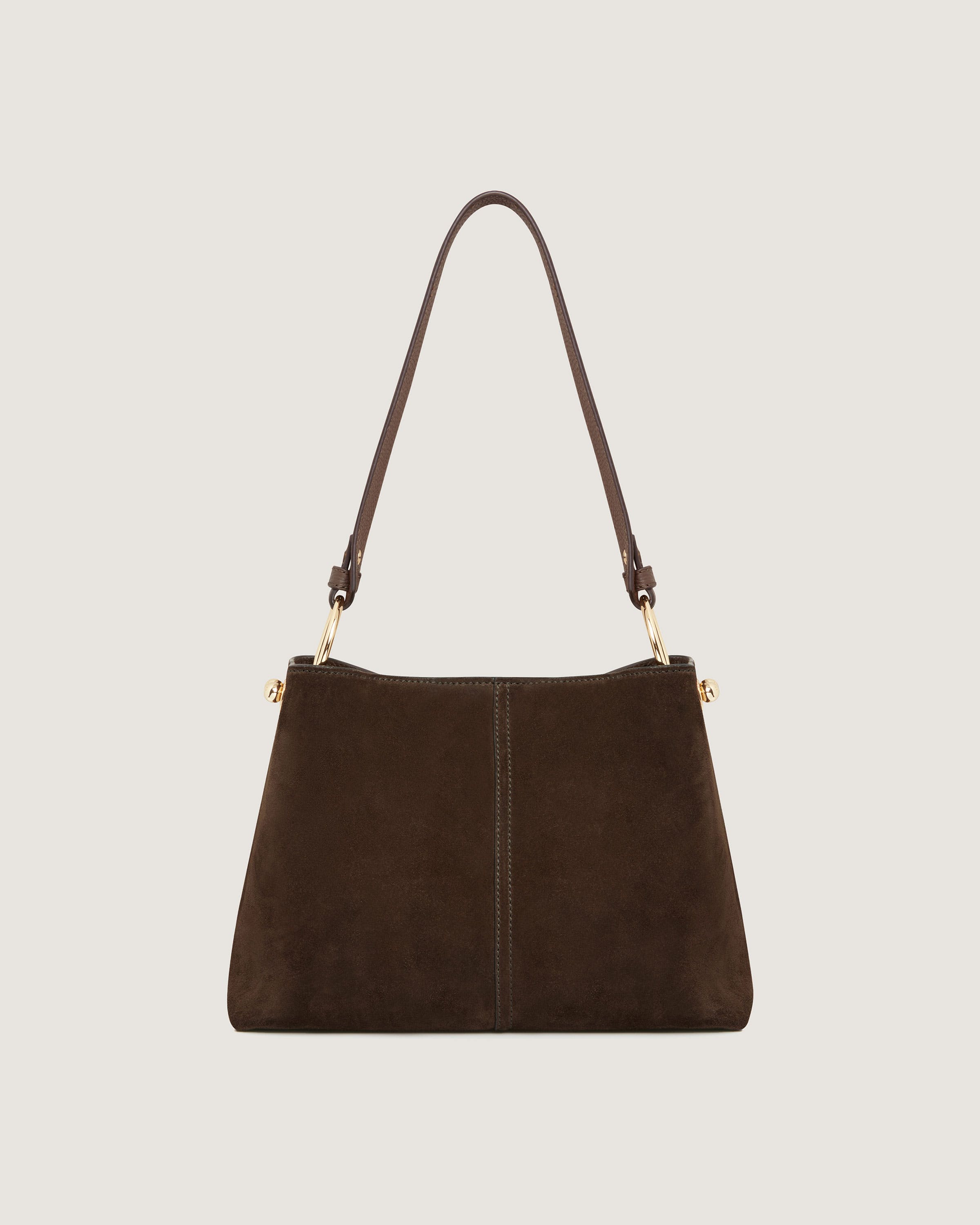 A brown sued handbag with a long strap