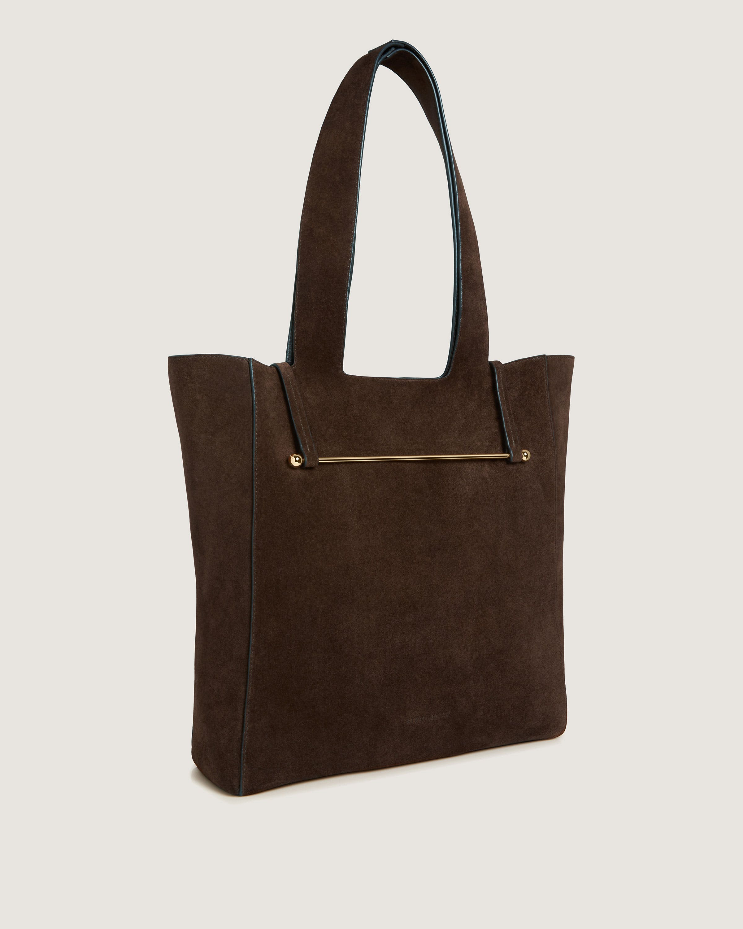 A brown suede tote bag with a zipper