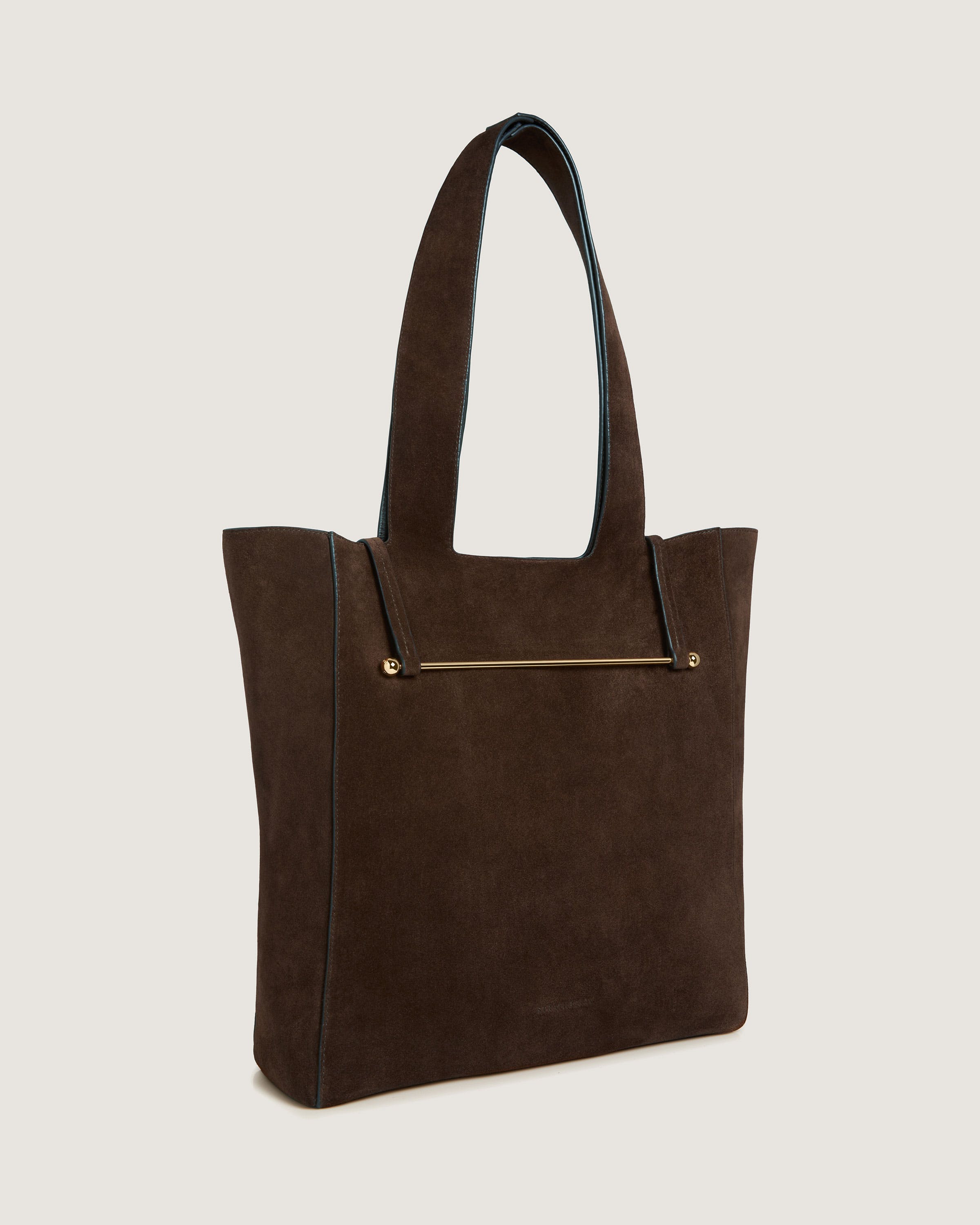 A brown suede tote bag with a gold zipper