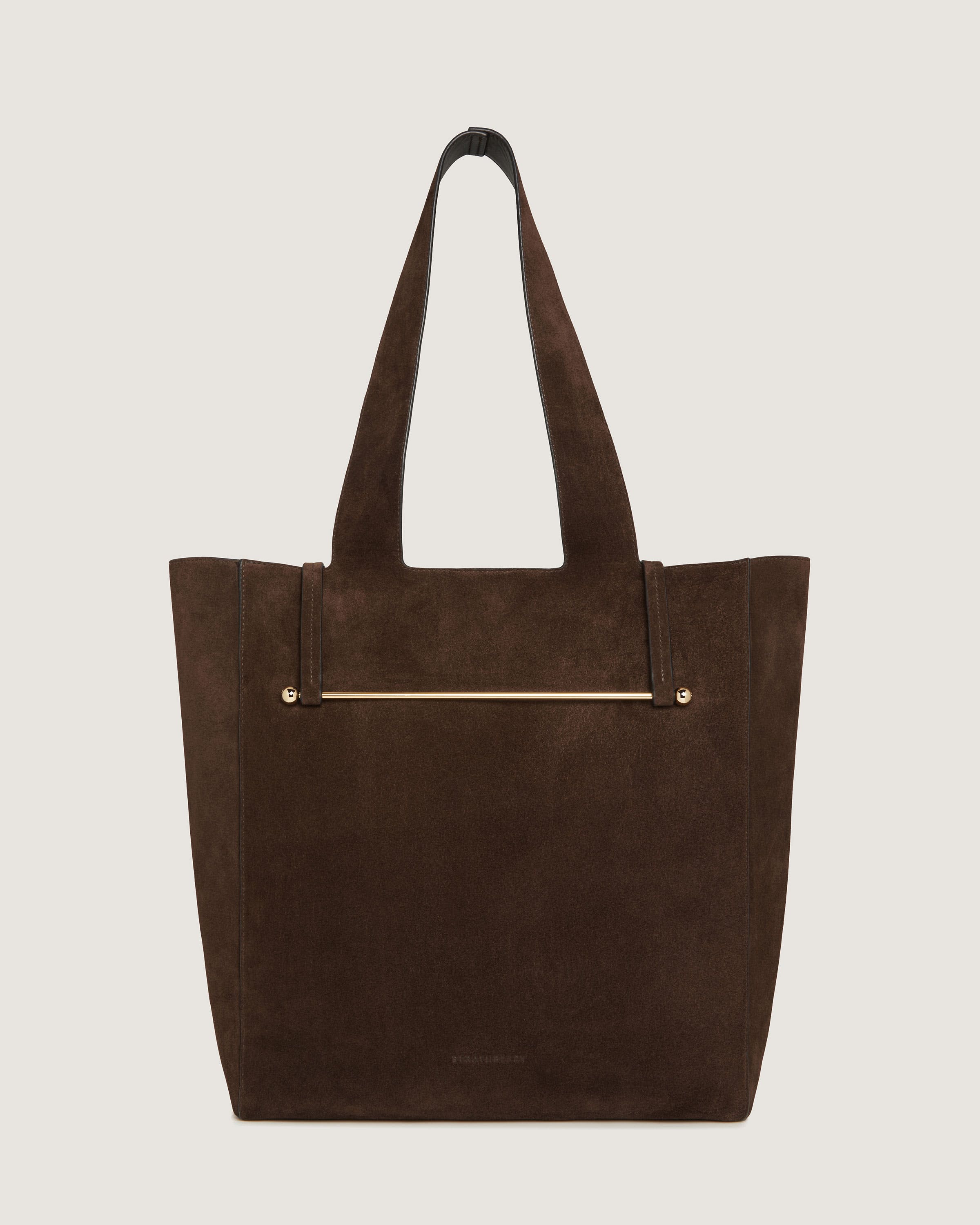 A brown suede tote bag with a gold zipper