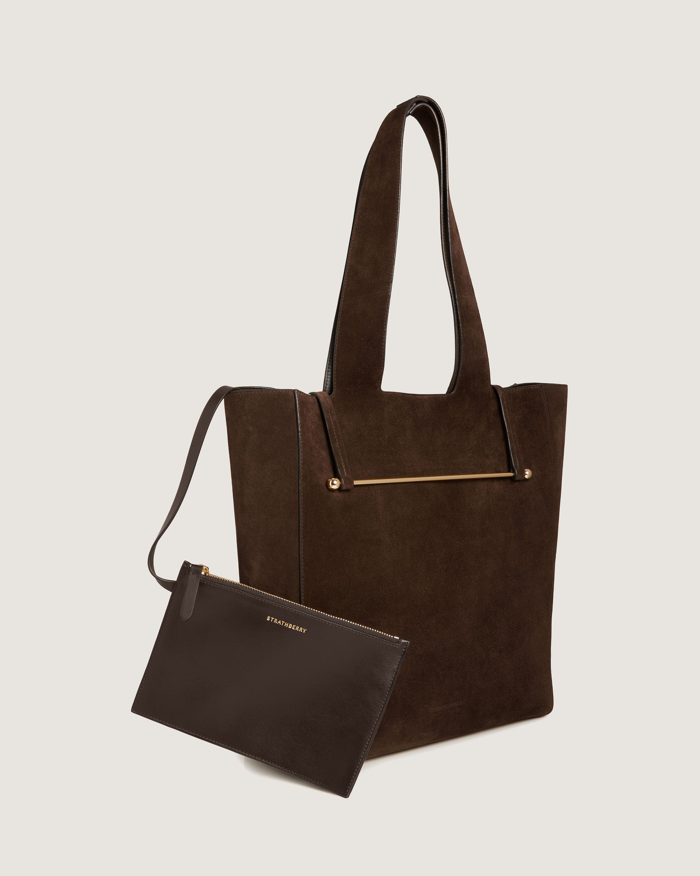 A brown bag and a brown purse on a white background